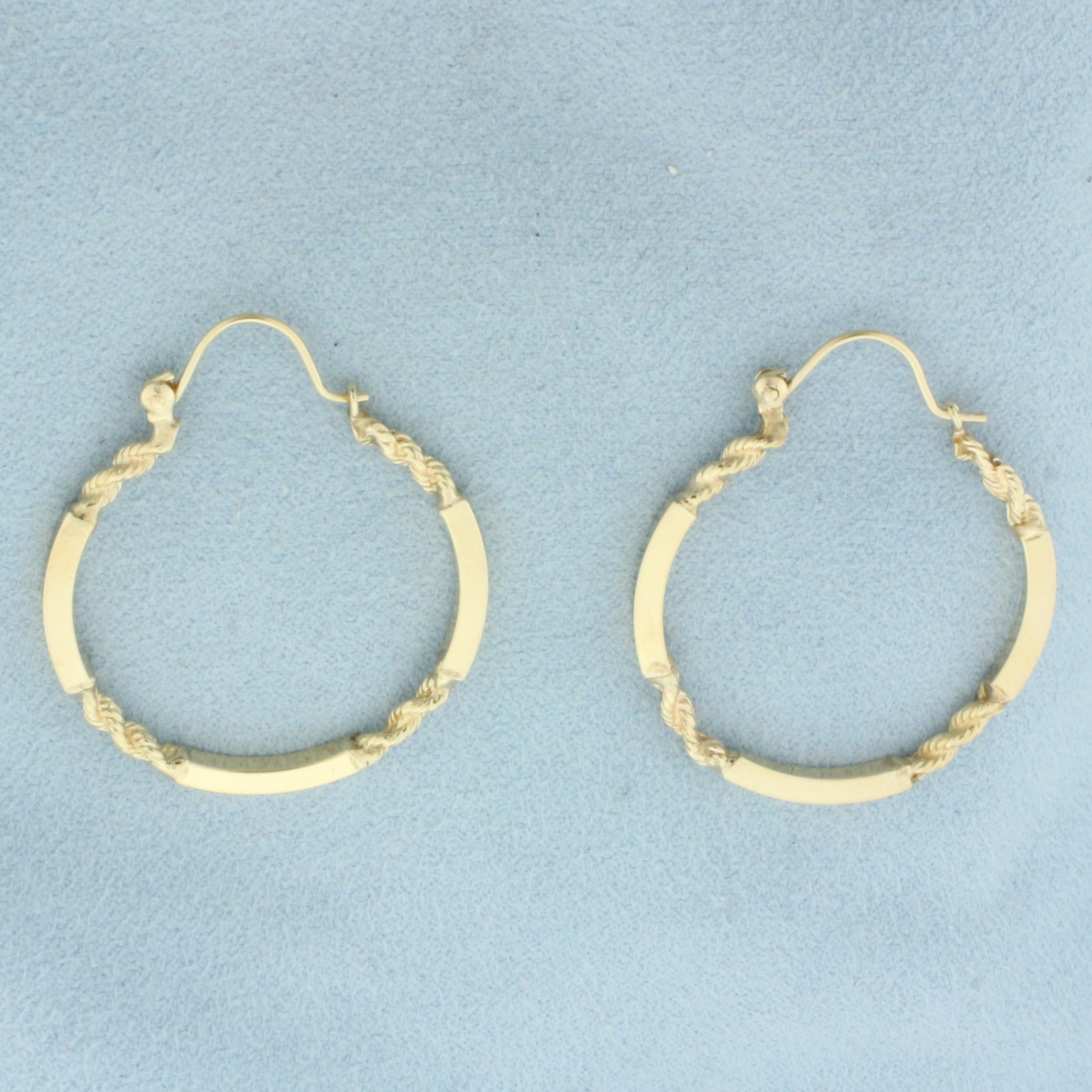 Unique Bar and Rope Hoop Earrings in 14k Yellow Gold: In 14k Yellow Gold. 1.5 inches long. 1.25 inches wide. Locking hook closure. 4.8g.