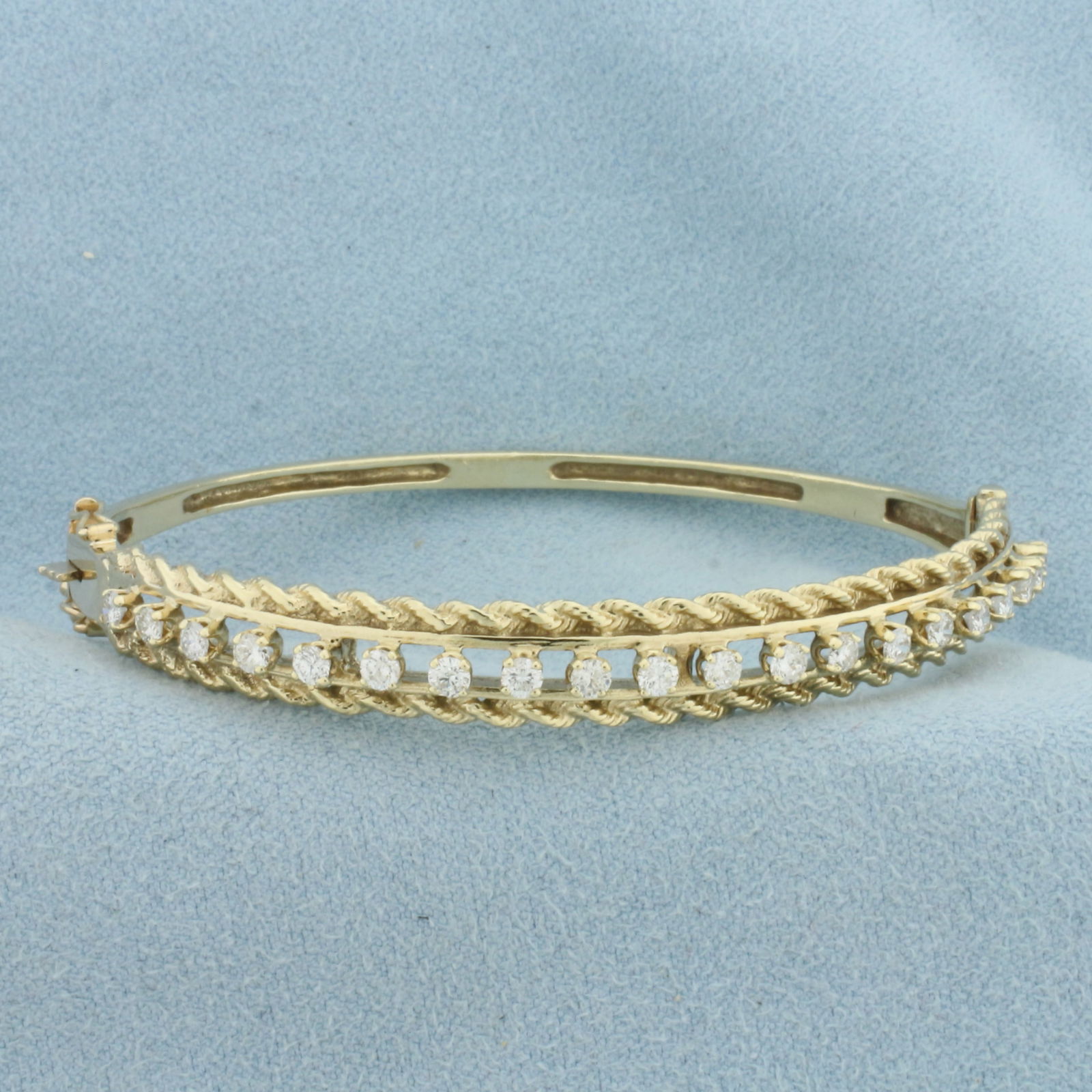 Diamond Rope Design Bangle Bracelet in 14k Yellow Gold: In 14k Yellow Gold. Contains twenty .05ct high quality diamonds, 1ct TW, VS clarity/G color. Interior dimensions: 2 1/4 by 2 inches. 7.6mm wide at center. Hinged closure with double safety latch. 13.5