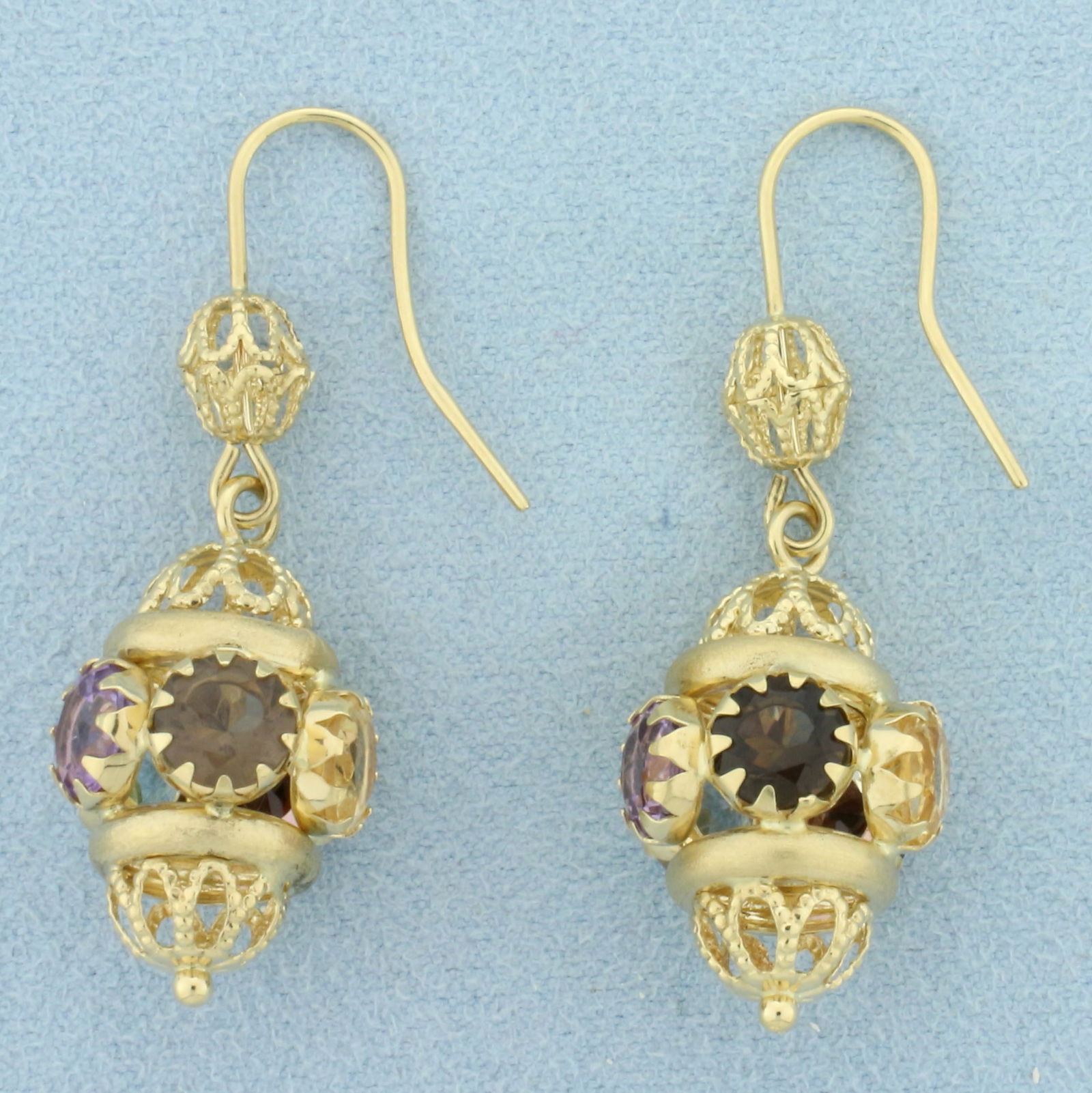 Multi Color Gemstone Dangle Chandelier Lantern Earrings In 18k Yellow Gold: In 18k yellow gold. Each earring contains five 1ct high quality natural gemstones including amethyst, blue topaz, citrine, garnet, and smoky topaz. Each with vibrant color and excellent clarity. Earri