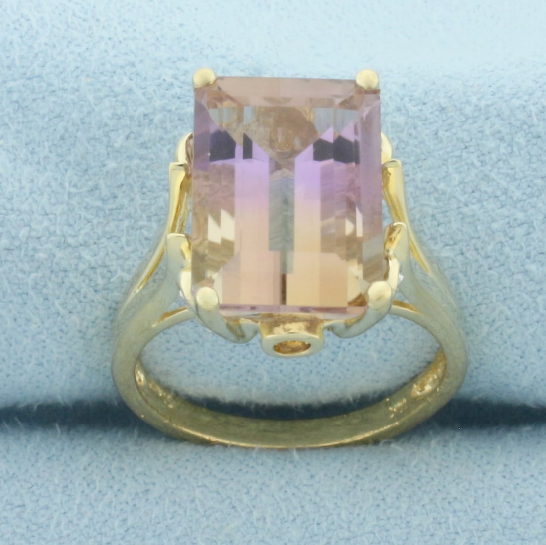 Ametrine and Diamond Ring in 10k Yellow Gold: In 10k Yellow Gold. Contains one 14x10mm high quality emerald cut natural Ametrine gemstone with intense color and excellent clarity. Also contains two 2mm high quality natural Citrine gemstones. Also