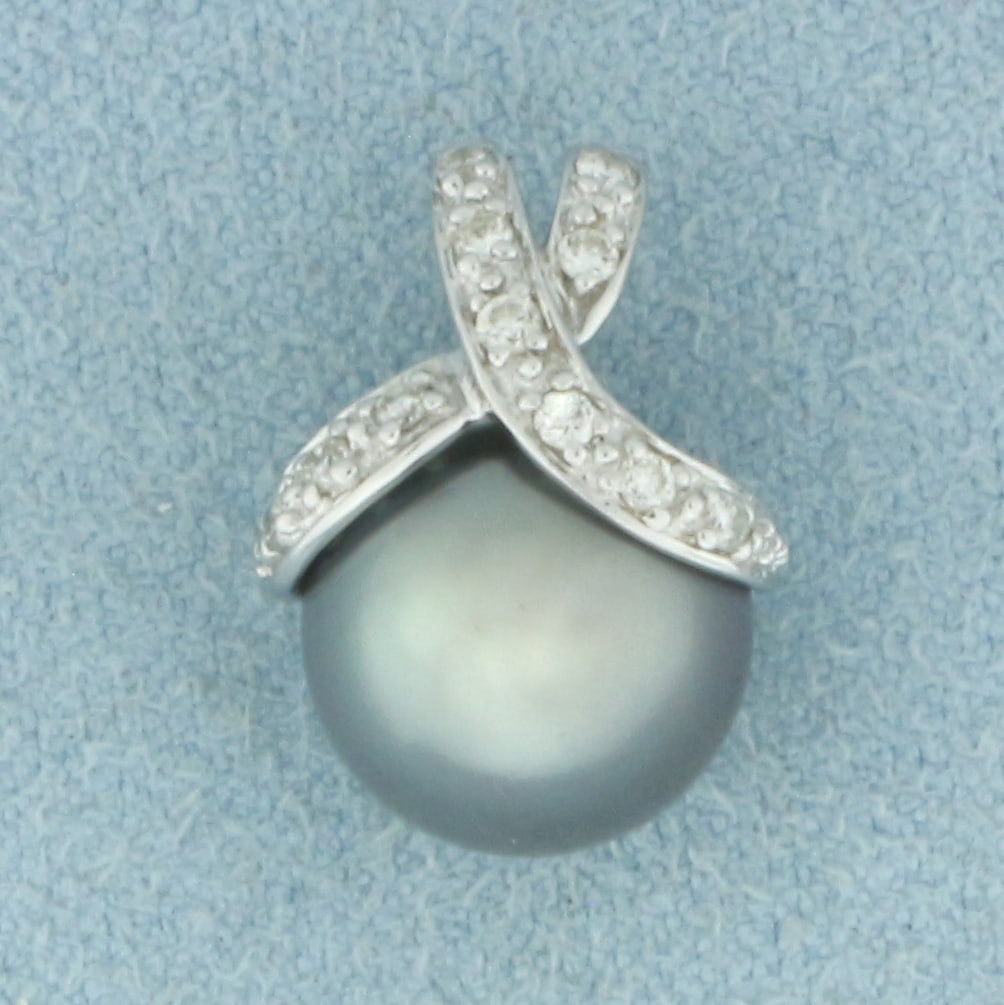 Tahitian Pearl and Diamond Pendant in 14k White Gold: In 14k White Gold. Contains one 10.4mm high quality Tahitian pearl gemstone with high luster and beautiful peacock undertone. Also contains twelve 1/2pt high quality diamonds. 5/8 inch long. 3/8 inch