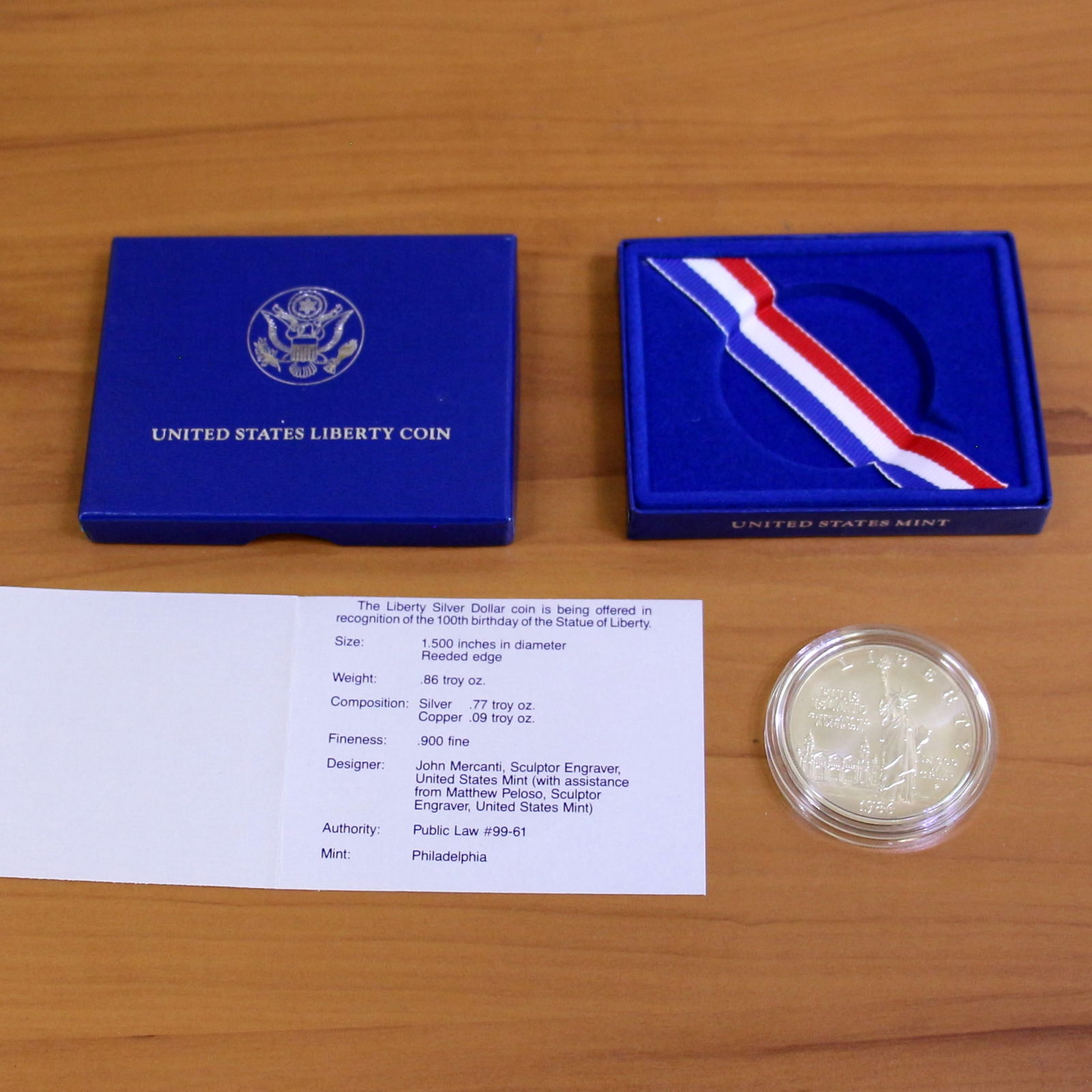US Mint 1986 Uncirculated Liberty Silver Dollar Coin OGP: Contains one 1986 Liberty Uncirculated Silver Dollar. Set in plastic casing, box, and contains certificate of authenticity.