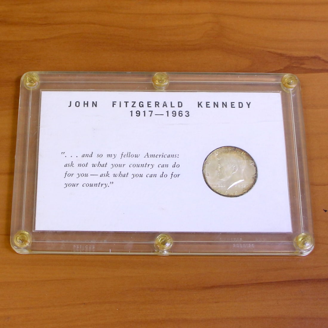 1964 John F. Kennedy Silver Half Dollar in Display Case: Contains one 1964 United States Mint John F. Kennedy Half Dollar. Set in plastic case.