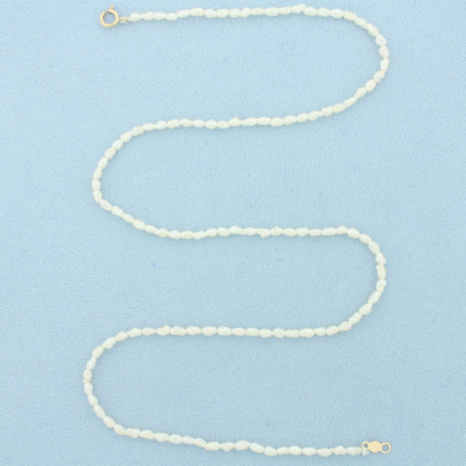Freshwater Pearl Necklace in 14k Yellow Gold: In 14k Yellow Gold. Contains 3mm high quality Freshwater Pearls with high luster. 16.5 inches long. 2mm wide. Spring clasp. 2.6g.