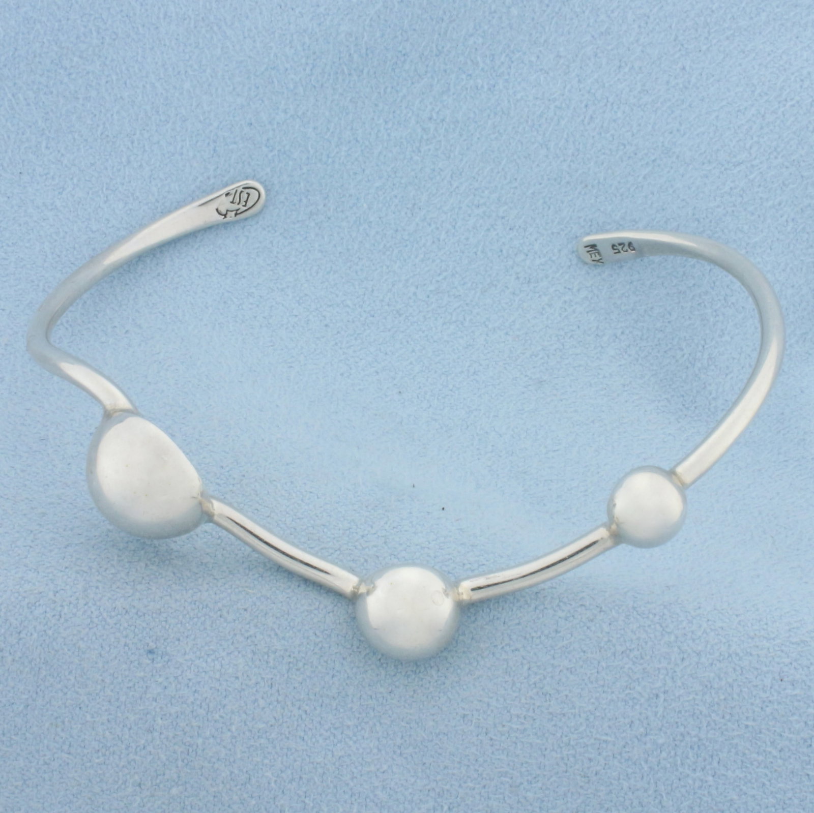 Three Bead Bangle Bracelet in Sterling Silver: In .925 sterling silver. 2 5/8 inch inner diameter. 2.30mm wide. 6mm to 12mm ball beads. 14.2g