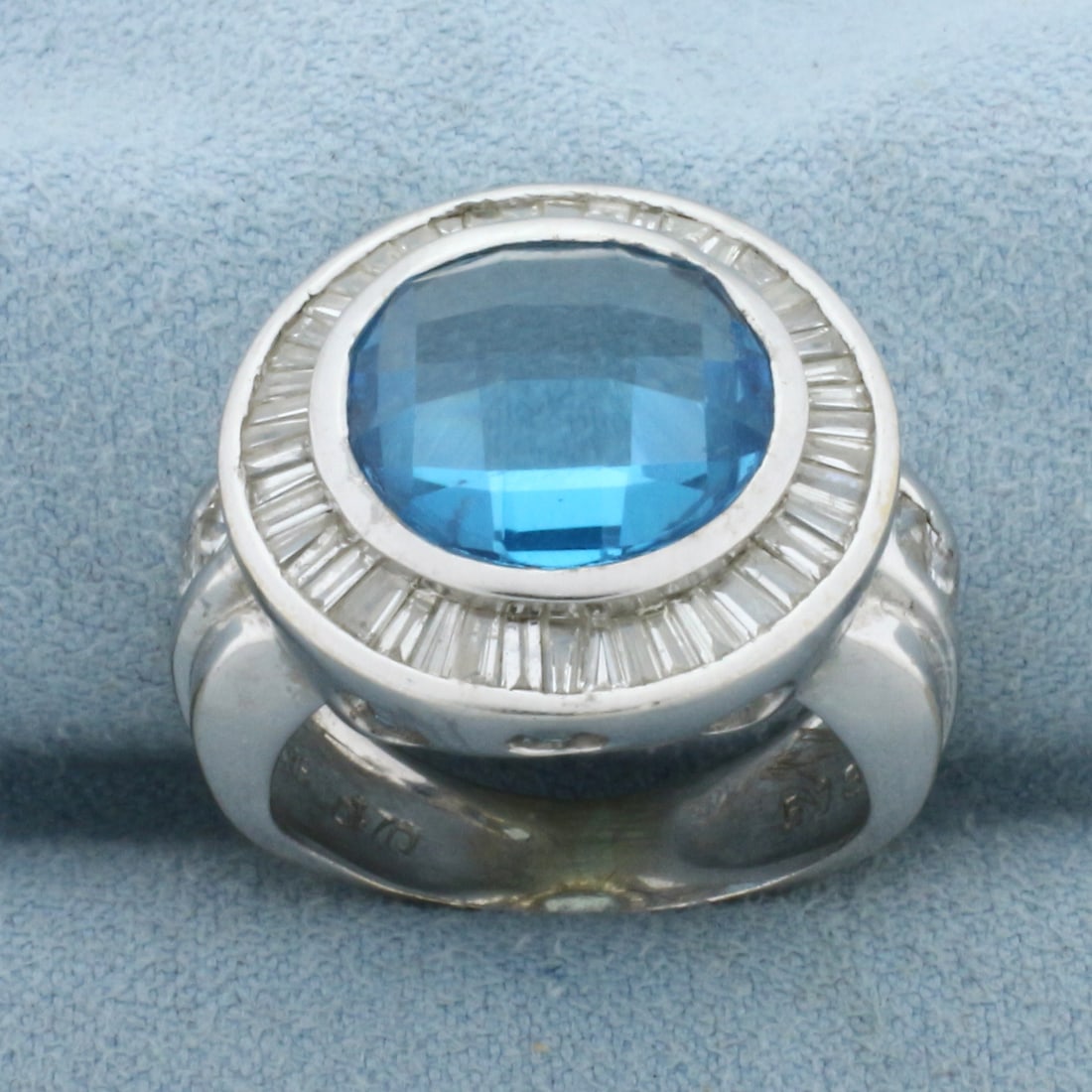 Checkerboard Cut Swiss Blue Topaz and Diamond Ring in 18k White Gold: In 18k White Gold. Contains one 5.13ct high quality natural Swiss Blue Topaz gemstone with electric blue color and excellent clarity. Also contains 1.70ct TW baguette and princess cut high quality dia