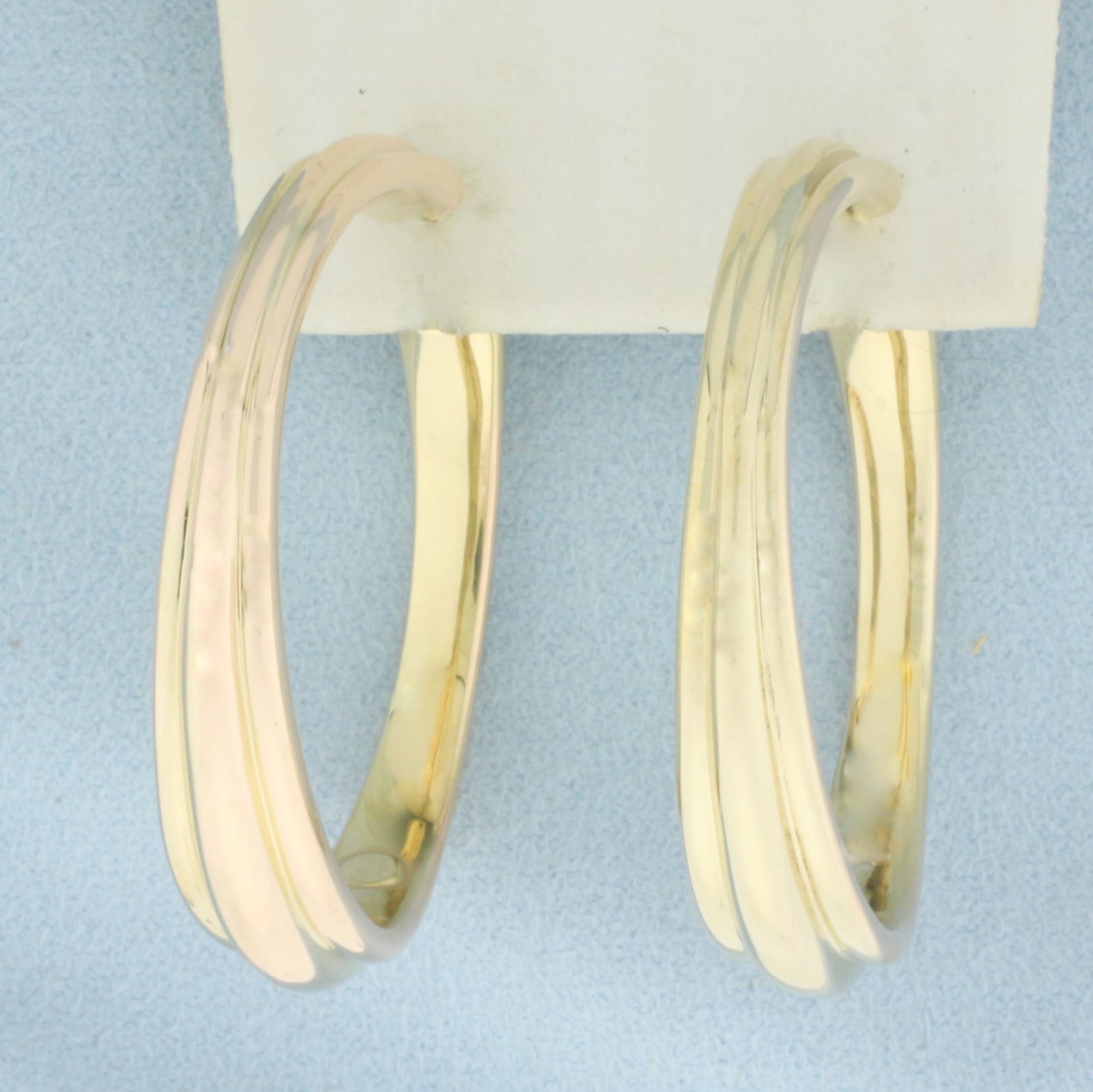 Large Hoop Earrings in 14k Yellow Gold: In 14k Yellow Gold. 1 5/8 inch long. 8mm wide at widest. Leverback. 5.5g.