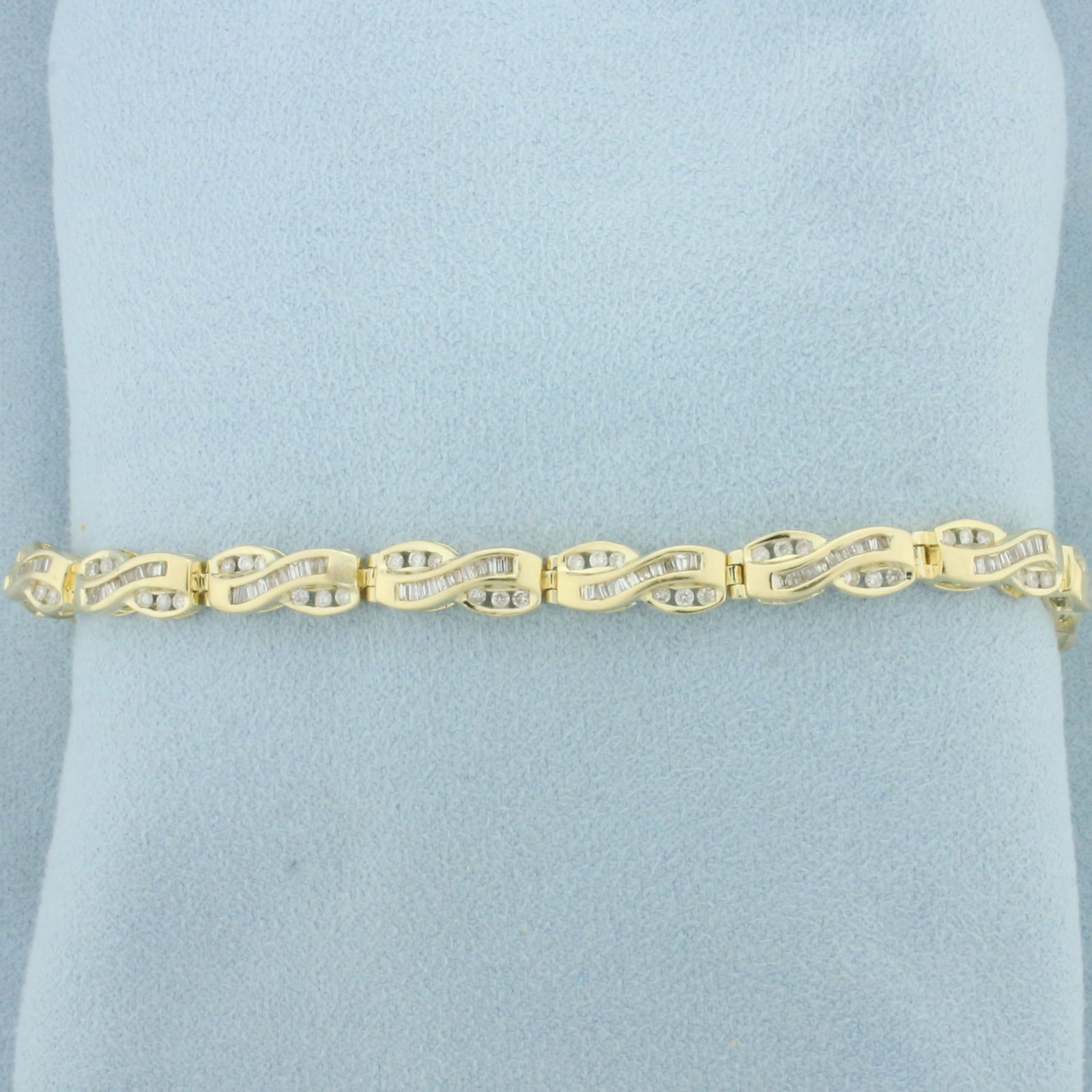 Baguette and Round Diamond Tennis Bracelet in 14k Yellow Gold: In 14k yellow gold. Contains 78 round brilliant and 130 baguette high quality diamonds, 2ct TW, I color/I clarity. 7 1/4 inches long, 5.6mm wide. Concealed slide clasp with safety latch and safety