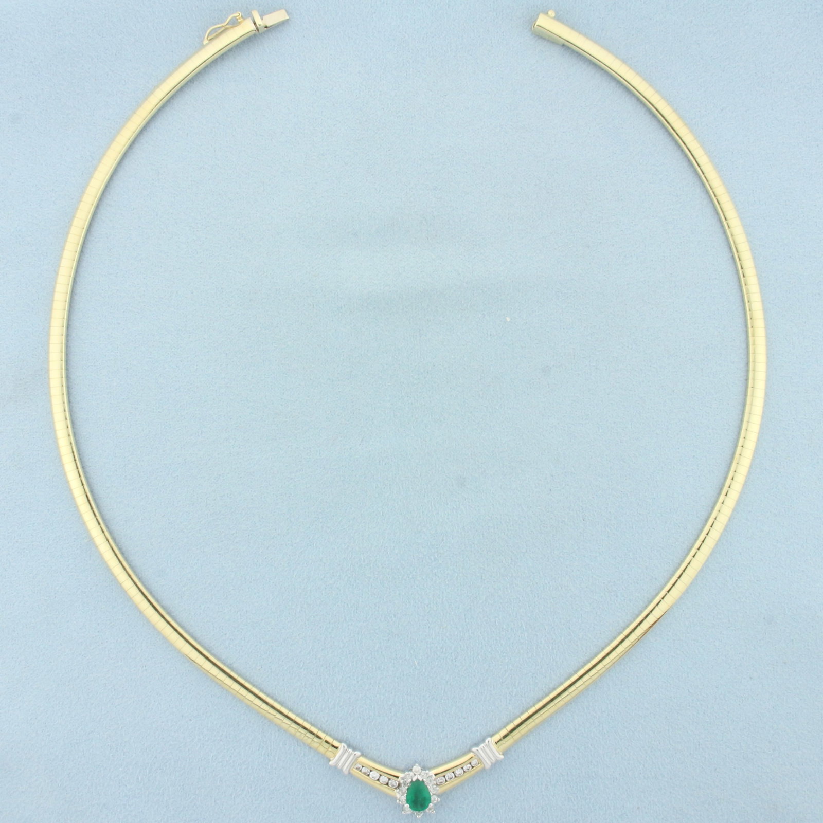 Emerald and Diamond Omega Necklace in 14k Yellow Gold: In 14k yellow gold. 16.5 inches long, 4mm wide. Contains one pear cut high quality natural 1/2ct emerald with vibrant green emerald color. Accented by twenty two high quality .03ct diamonds, VS clarit