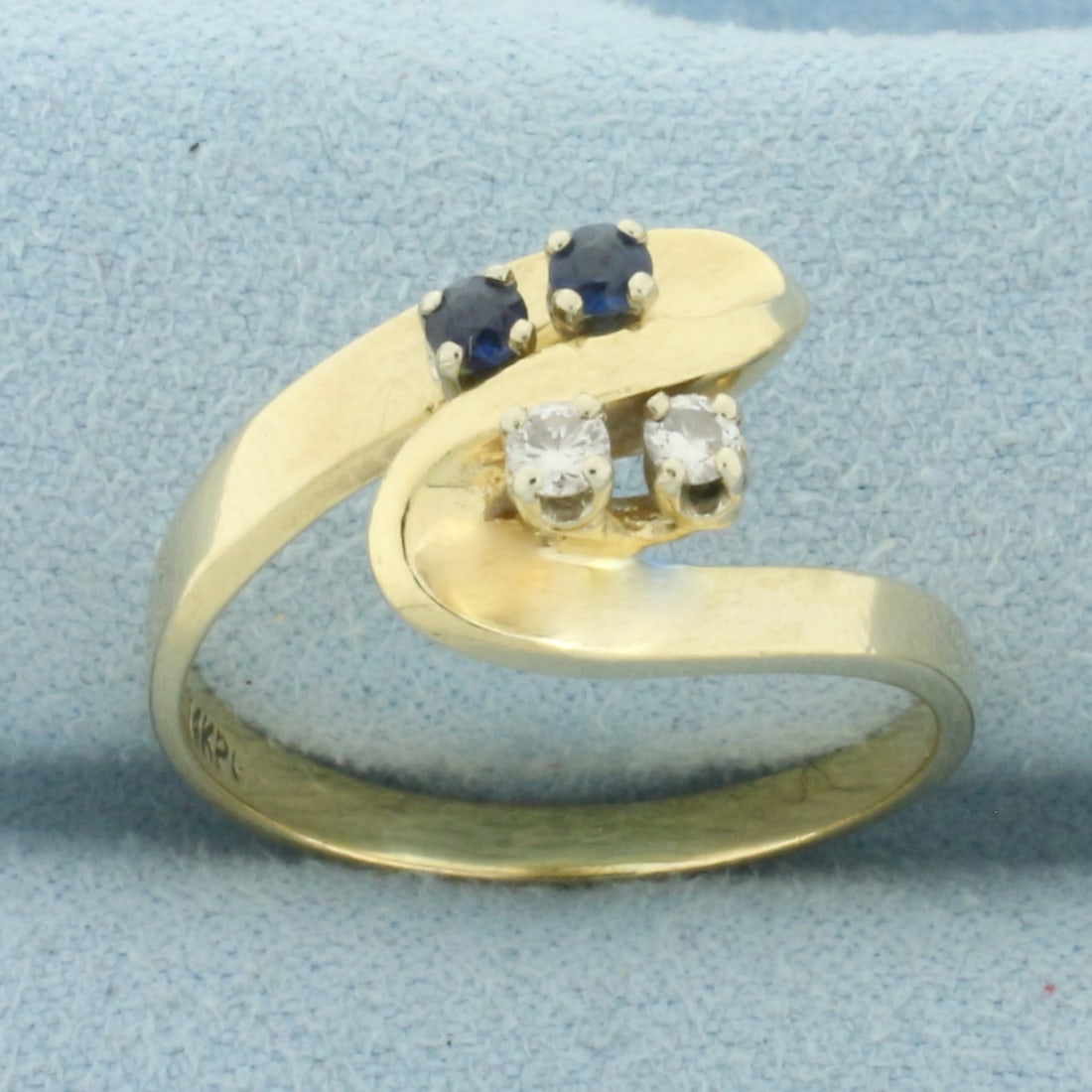 Sapphire and Diamond Toi et Moi Ring in 14k Yellow Gold: In 14k Yellow Gold. Contains two high quality .05ct natural Sapphire gemstones with intense color and excellent clarity. Also contains two .05ct diamonds, VS clarity/G color. 11.1mm wide at widest spr