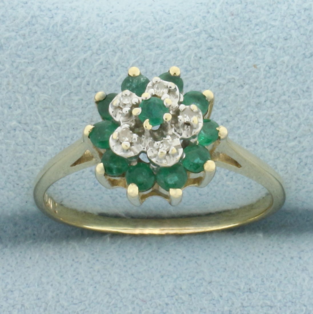 Emerald and Diamond Flower Ring in 10k Yellow Gold: In 10k Yellow Gold. Contains eleven high quality 2.5mm natural Emerald gemstones with intense color. Also contains five high quality 1/2pt diamonds. 11mm wide. Size 9. 2.9g.