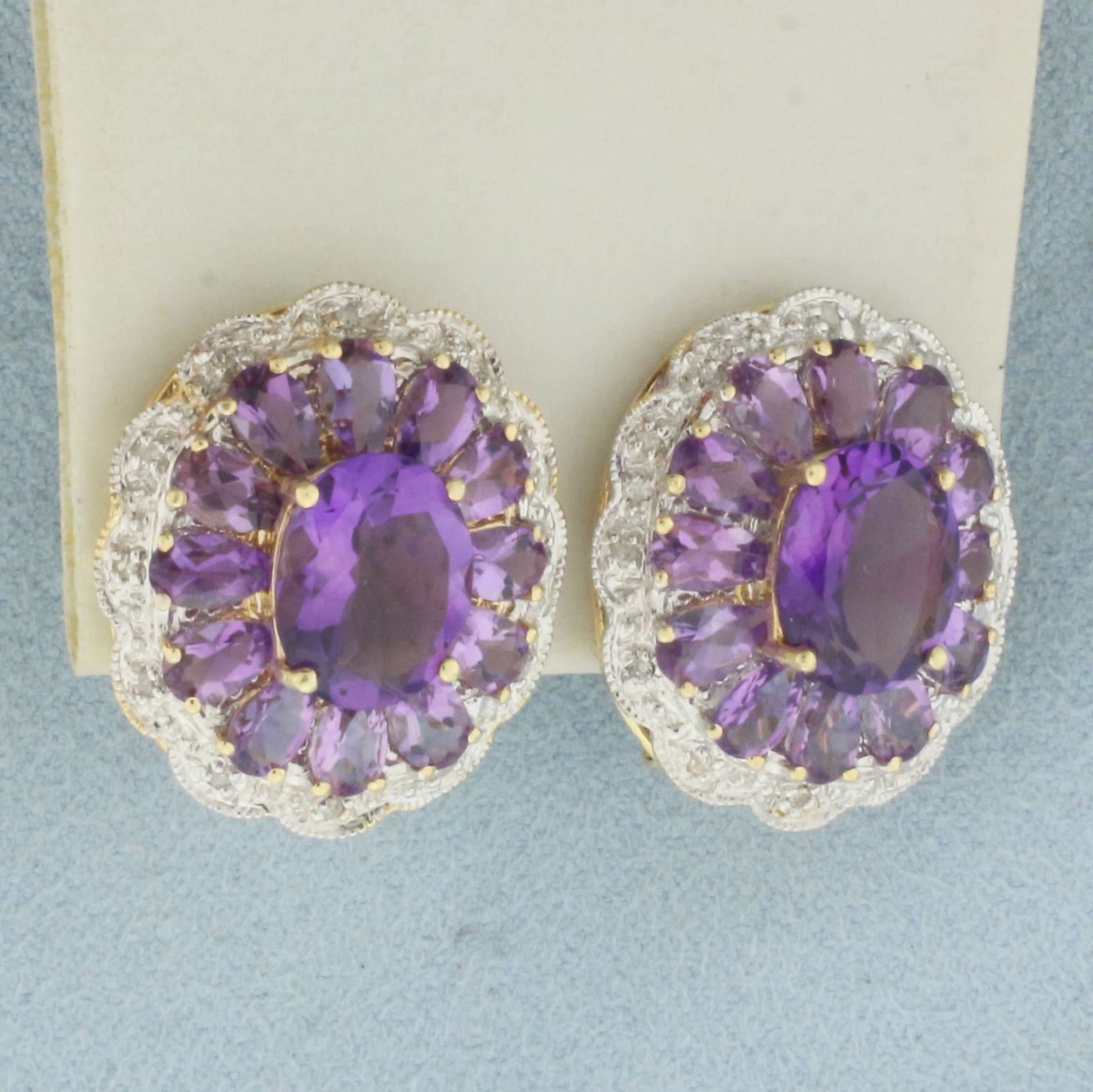 Amethyst and Diamond Earrings in 14k Yellow Gold: In 14k yellow gold. 7/8 inches long, 3/4 inches wide. Contains two 10x8mm oval and twenty four 5x3mm high quality Amethyst gemstones with vibrant color and excellent clarity. Also contains twenty four