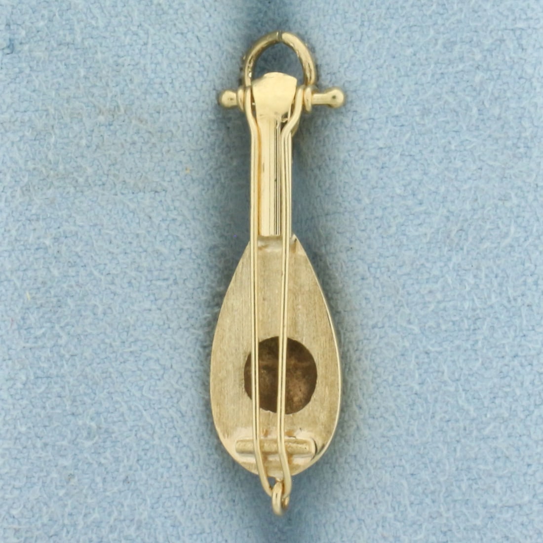 Mandolin Charm in 14k Yellow Gold: In 14k Yellow Gold. 1 1 /4 inches long including jump ring. 5/16 inch wide. 1.8g.