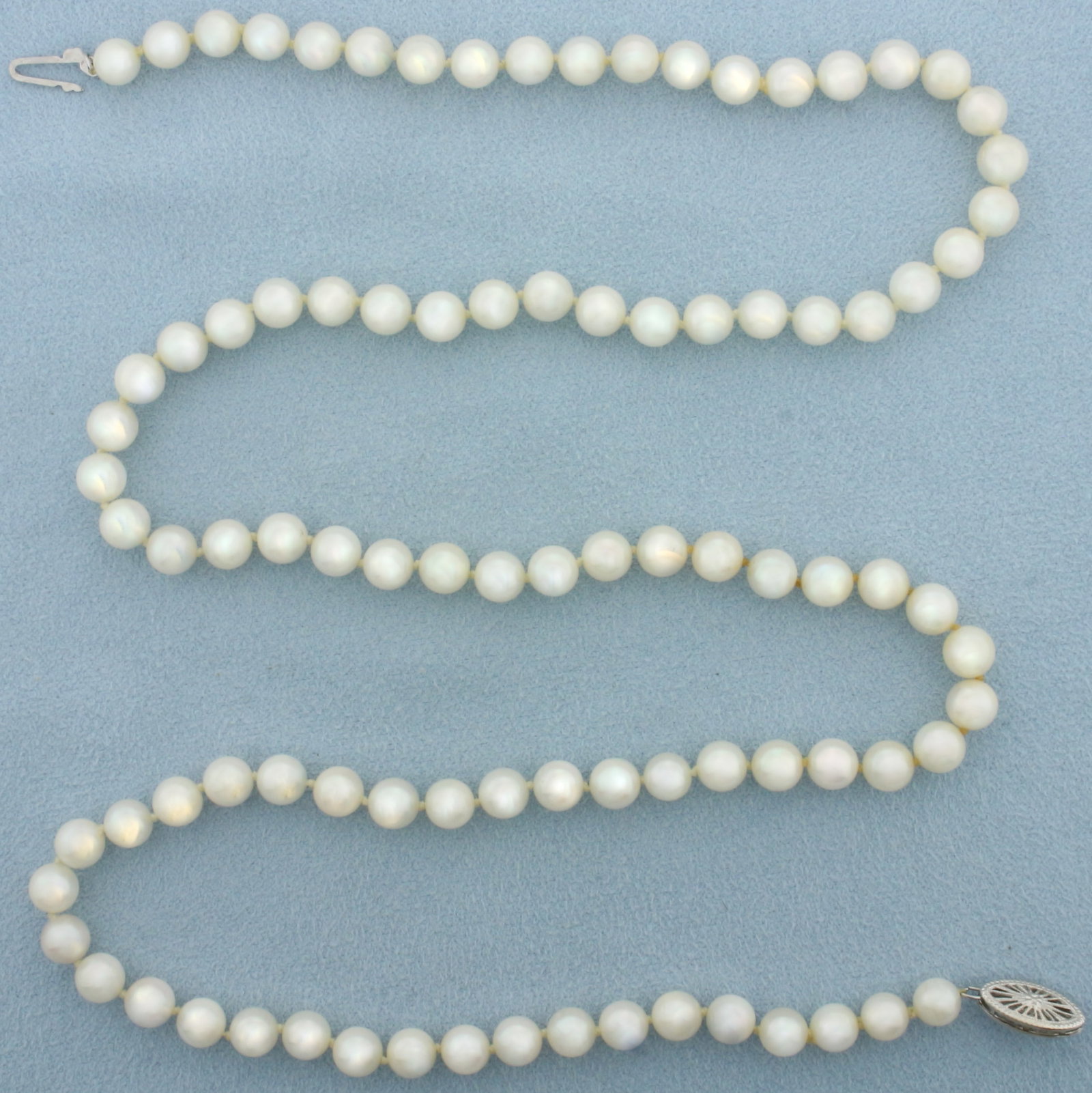 Cultured Akoya Pearl Strand Necklace with 14k White Gold Filigree Locking Clasp: 14k White Gold Filigree Locking Clasp. Contains high quality 6mm cultured akoya pearls with high luster. 24 inch long. Hand knotted. 26.7g.