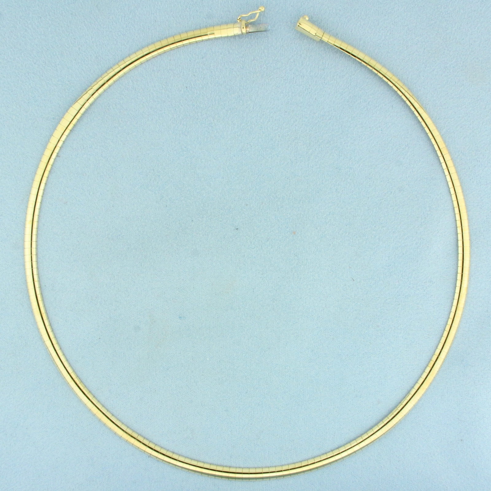 17 Inch Italian Omega Link Necklace in 10k Yellow Gold: In 10k Yellow Gold. 17 inches long. 4mm wide. Italian made. Concealed slide clasp with safety latch. 15.5g.