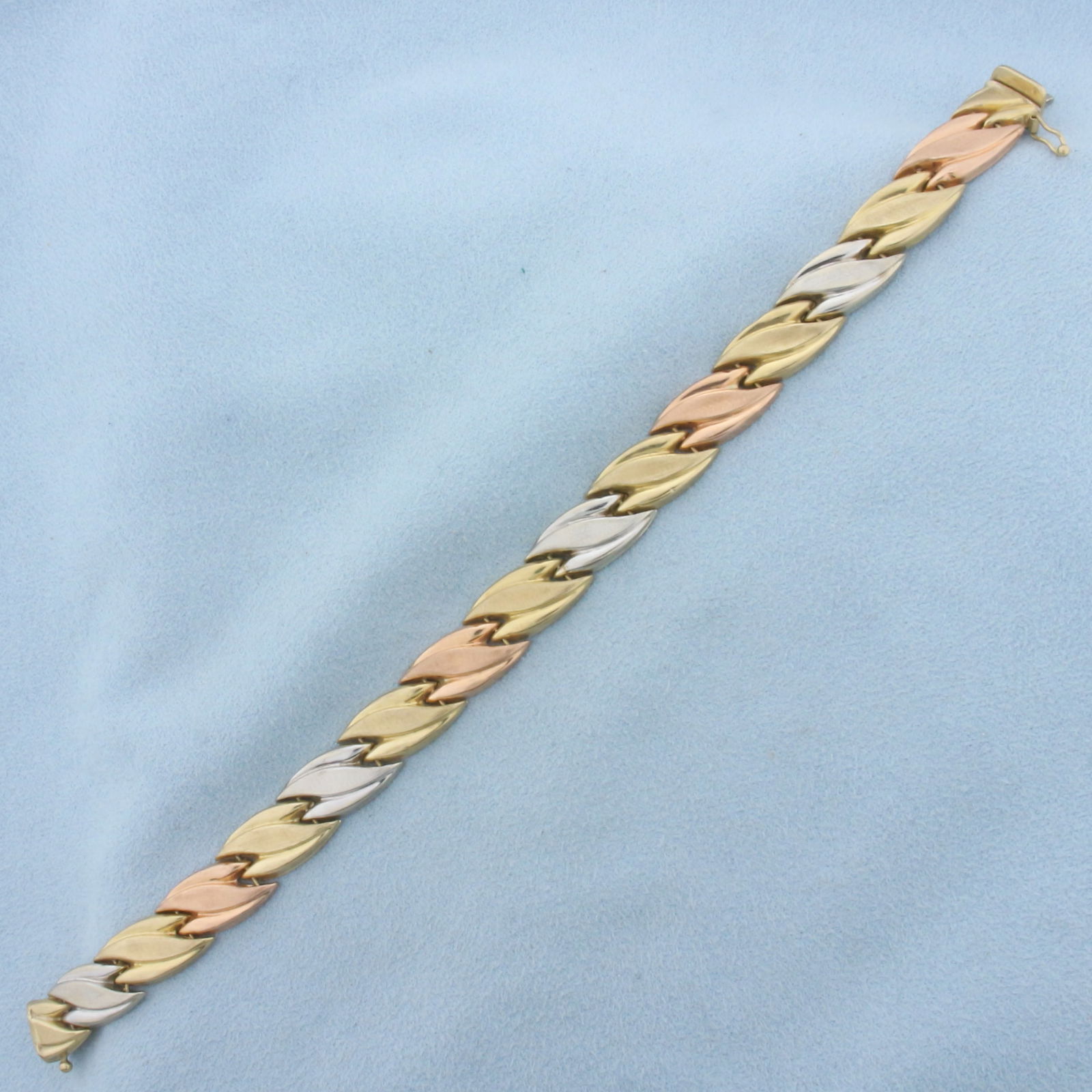 Tri Color Designer Link Bracelet in 10k White, Yellow and Rose Gold: In 10k white, yellow, and rose gold. 7 1/2 inches long 10mm wide. Has very minor indentation as shown in photos, not noticeable. Safety clasp. 9.5g.