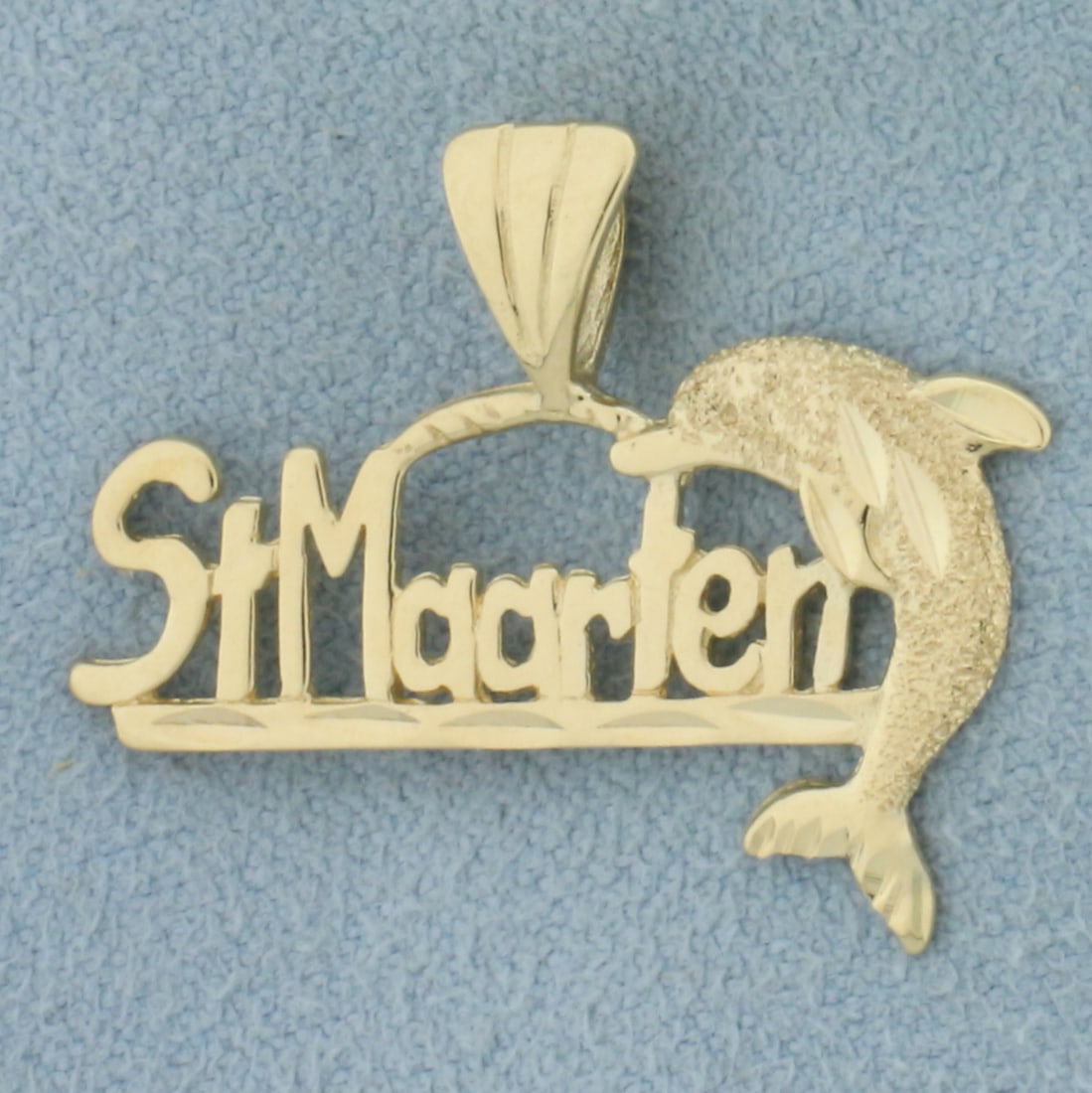 St. Maarten Dolphin Pendant in 14k Yellow Gold: In 14k yellow gold. 3/4 inches high by 1 1/8 inches wide. 1.5g.