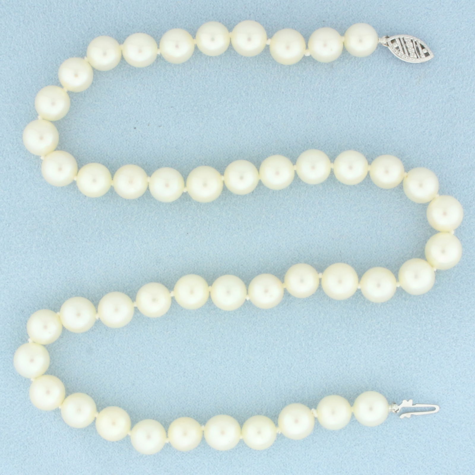 Cultured Akoya Pearl Strand Necklace with 14k White Gold Filigree Locking Clasp: In 14k White Gold Filigree Locking Clasp. Contains forty-six high quality 7.5mm cultured Akoya Pearls with high luster. 15 inches long. Hand knotted. 29.8g.