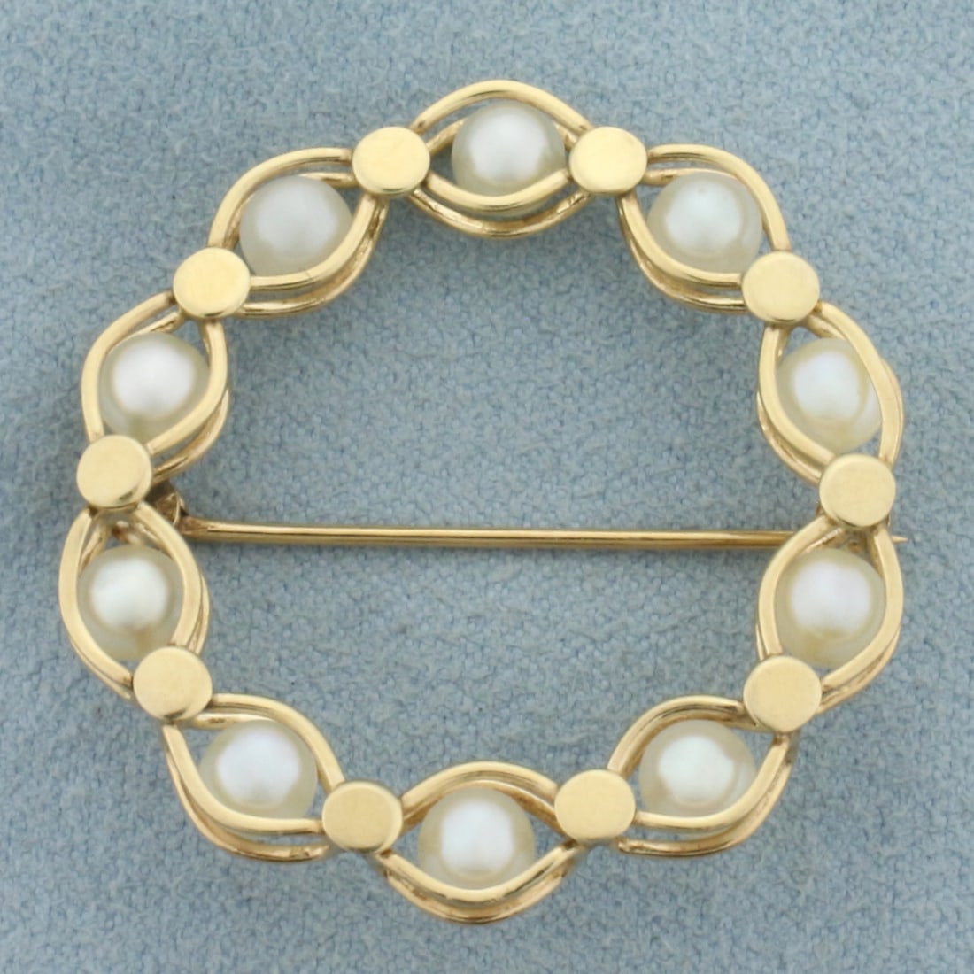 Cultured Pearl Motion Circle Pin Brooch in 14k Yellow Gold: In 14k Yellow Gold. Contains ten 4.5mm high quality Cultured Pearls with high luster. 1 3/8 inch long. 1 1/4 inch wide. Pearls move in their caged places. 5.4g.