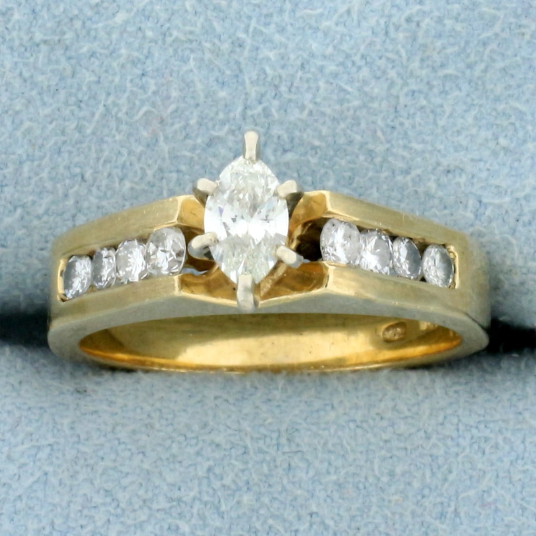 Vintage Diamond Marquise Engagement Ring in 14k Yellow Gold: In 14k yellow gold. Contains a center high quality .35ct marquise diamond, SI clarity/H color with great cut for lots of sparkle. It is surrounded by eight .05ct diamonds of similar high quality.