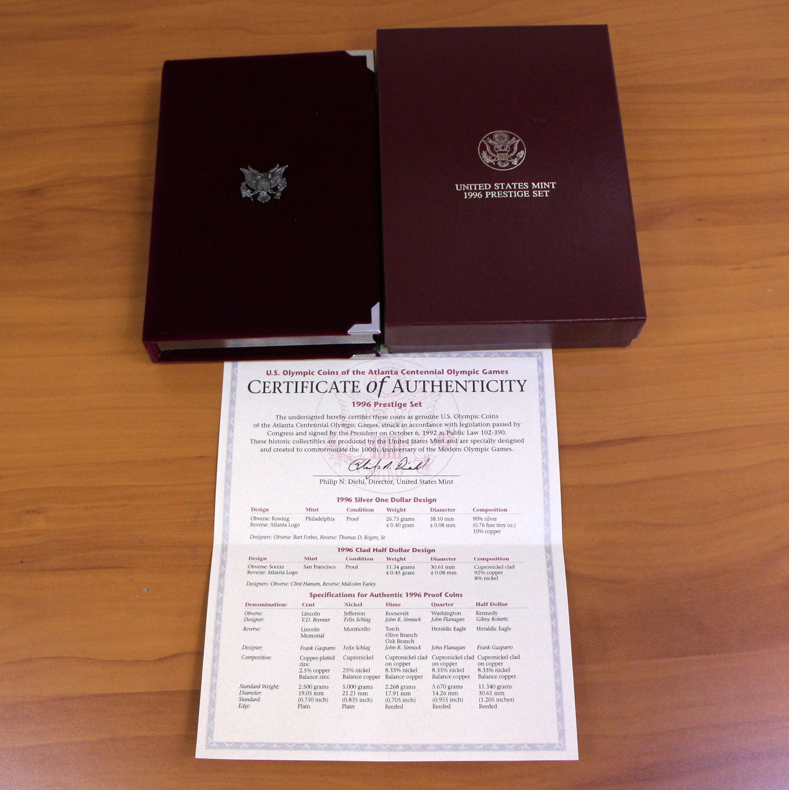 US Mint Atlanta Centennial Olympic Games Prestige Coin Set OGP: 1996 United States Mint Atlanta Centennial Olympic Games Prestige Set with one 1996 90% Silver Commemorative Silver Dollar. Set in original packaging and contains certificate of authenticity.