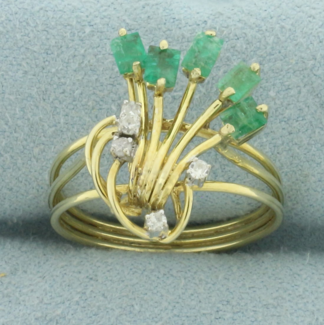 Emerald and Diamond Wirework Ring in 14k Yellow Gold: In 14k yellow gold. Contains five high quality .02ct diamonds, SI clarity/H color. Also contains five high quality 3mm high quality natural emeralds with vibrant color. Size: 7.5. 3.1g.