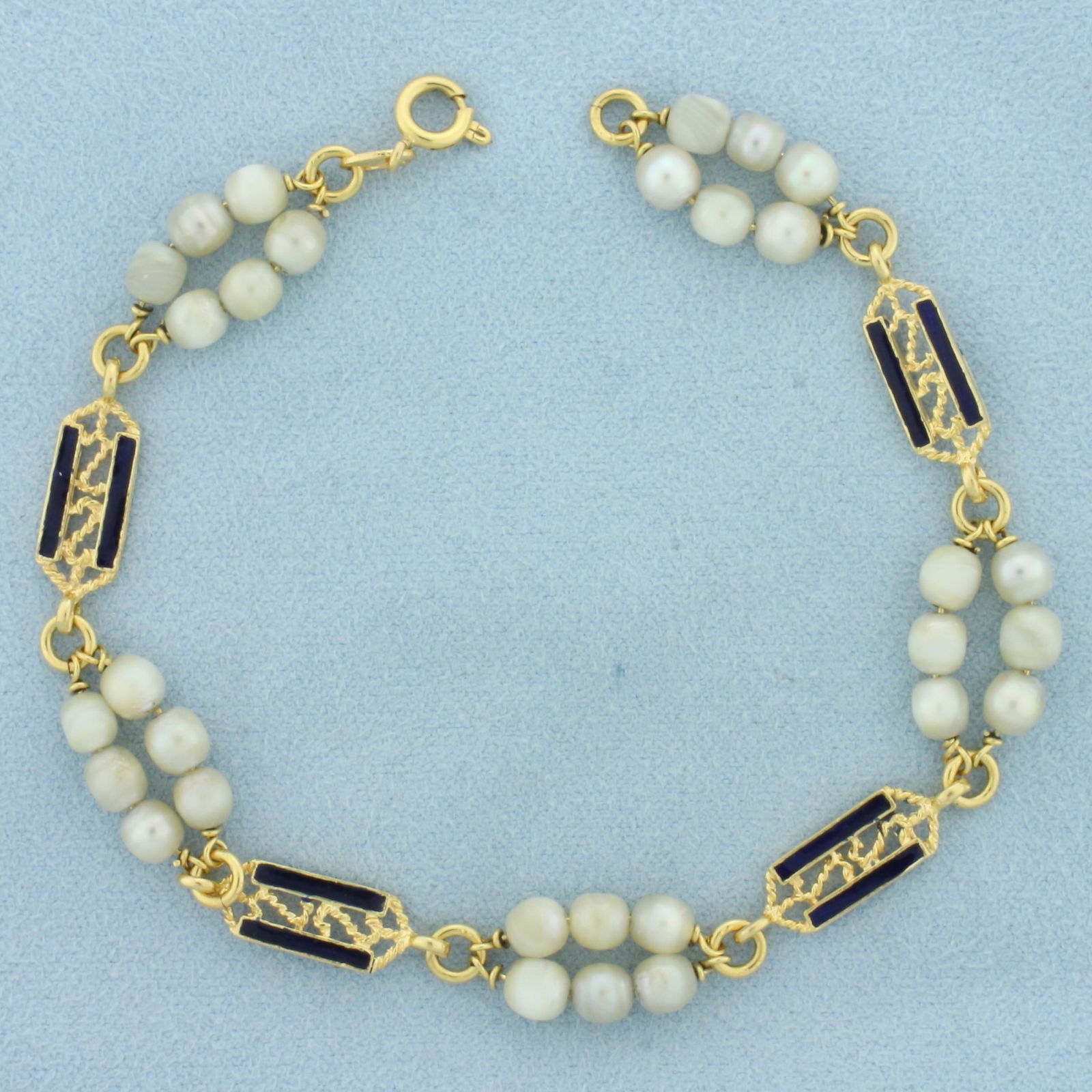 Italian Vintage Pearl Enamel Bracelet in 18k Yellow Gold: In 18k yellow gold. Contains thirty high quality 4mm pearls. Blue enamel inlay detail. 7.75 inches long and 3/8 inches wide. Spring clasp. 9.1g.