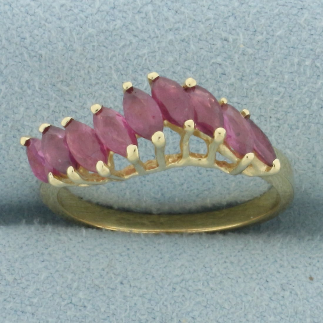 Natural Ruby Wave Design Ring In 14k Yellow Gold: In 14k yellow gold. Contains 9 high quality natural marquise cut ruby gemstones, 5mm x 2.5mm each, 2ct TW, with vibrant color. Size: 7.