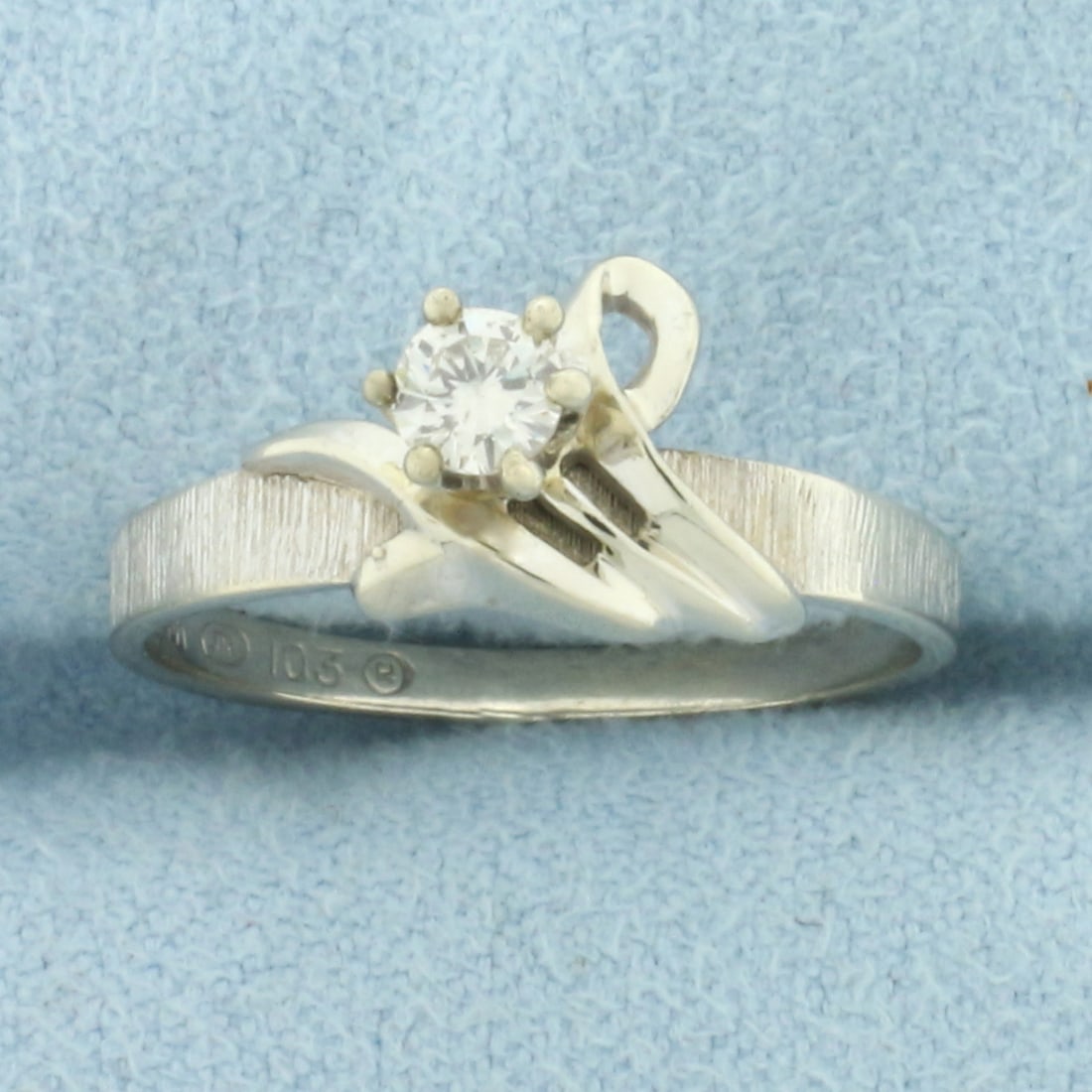 Designer Diamond Solitaire Ring in 14k White Gold: In 14k white gold. Contains one high quality 1/5ct diamond, H color/I clarity, eye clean, great cut for lots of sparkle. Unique etched finish on shoulders of ring for added brilliance. Size: 6. 2.2g.