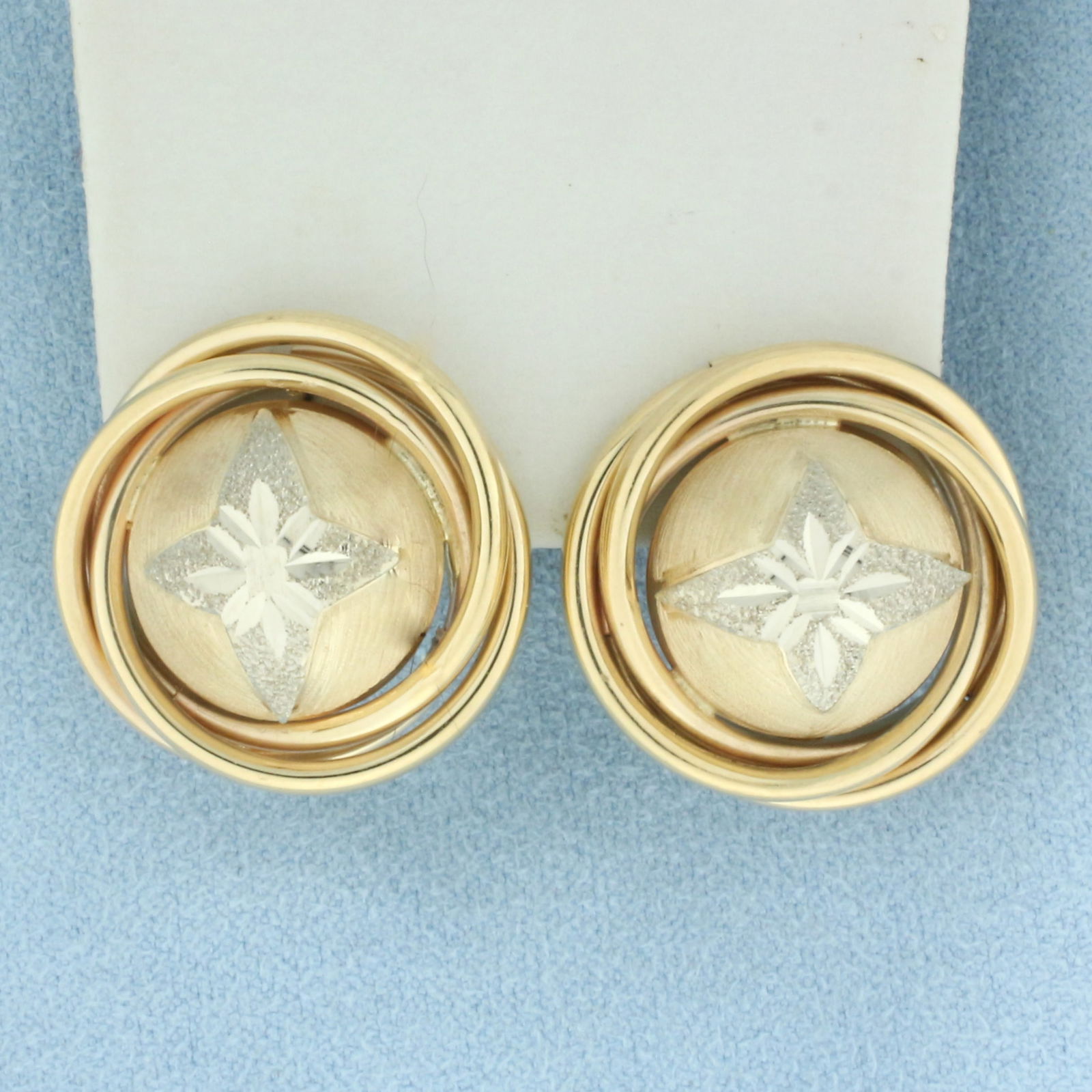 Diamond Cut Star Button Earrings in 14k Yellow and White Gold: In 14k yellow and white gold. 7/8 inch diameter. Diamond cut. Omega backs. 8.4g.