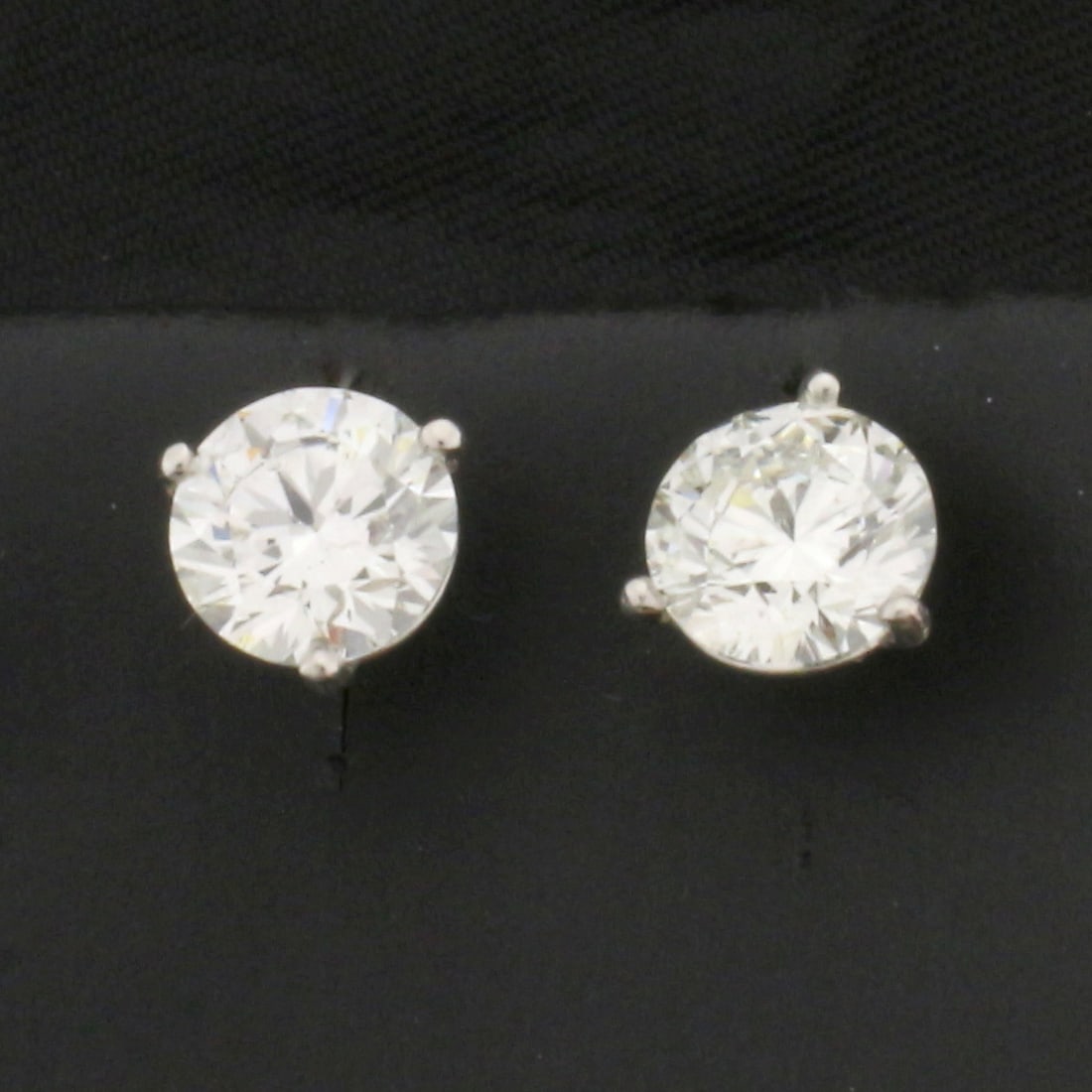 GIA Certified Over 2ct TW Diamond Stud Earrings in Platinum Martini Settings: In platinum martini settings. Contains one 1.09ct and one 1.12ct high quality round brilliant diamonds, J color/SI2 clarity, triple excellent cut for amazing brilliance, eye clean. No fluorescence. Ea