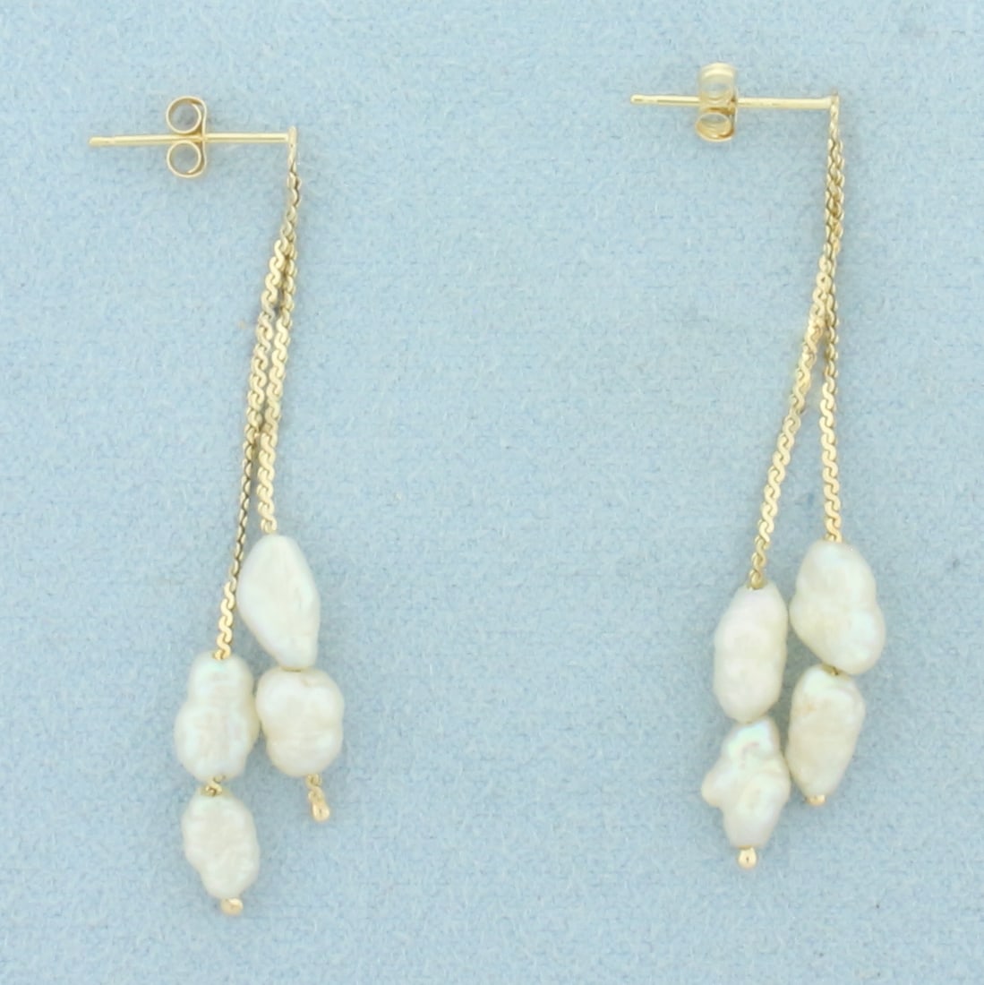 Baroque Pearl Dangle Earrings in 14k Yellow Gold: In 14k Yellow Gold. Contains eight high quality Freshwater Baroque Pearl gemstones with high luster. 1 3/4 inch long. Friction backs. 1.9g.