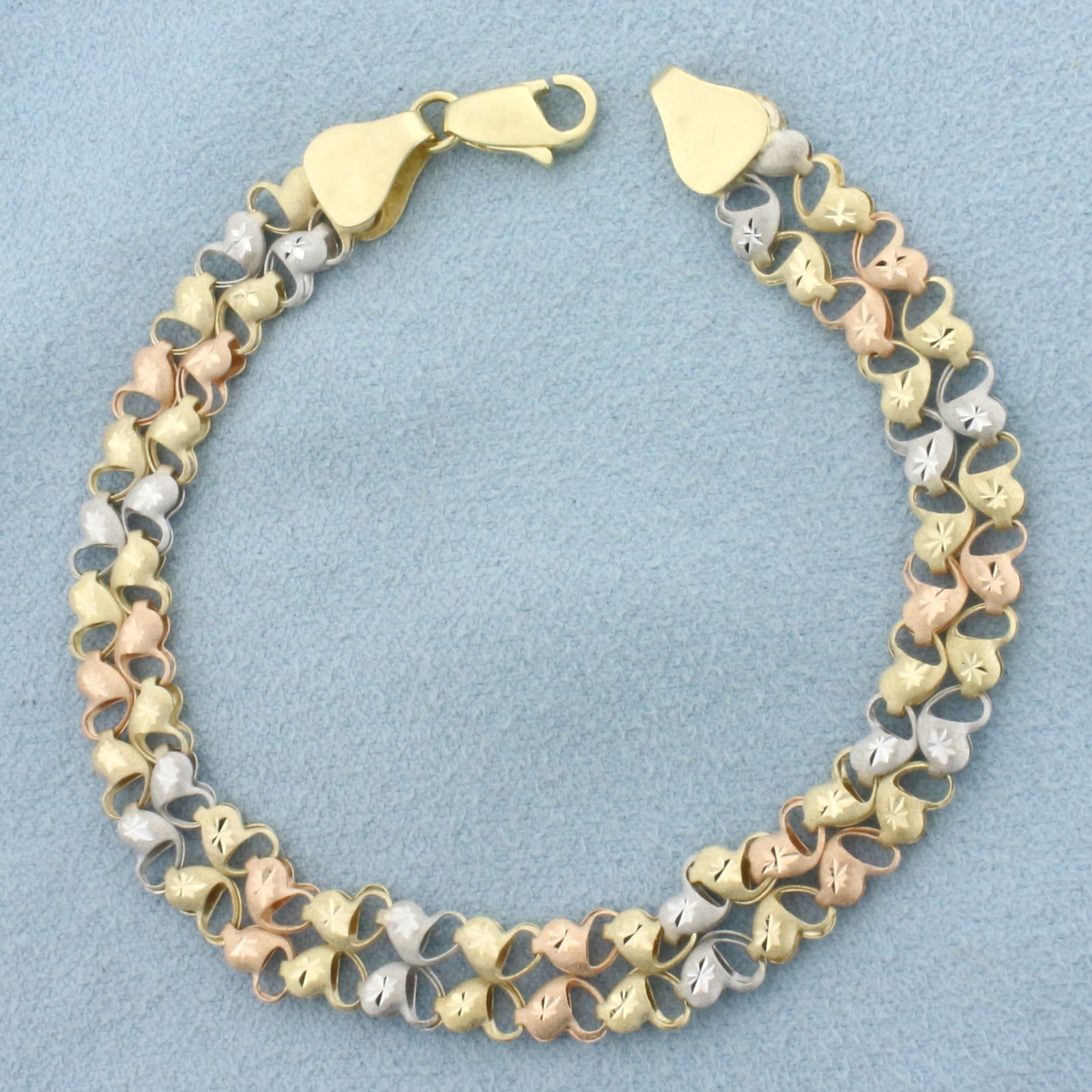Diamond Cut Heart Link Bracelet in 14k Yellow, Rose, and White Gold: In 14k Yellow, Rose, and White Gold. 7 3/8 inches long. 3/8 inch wide. Lobster clasp. 6.0g.