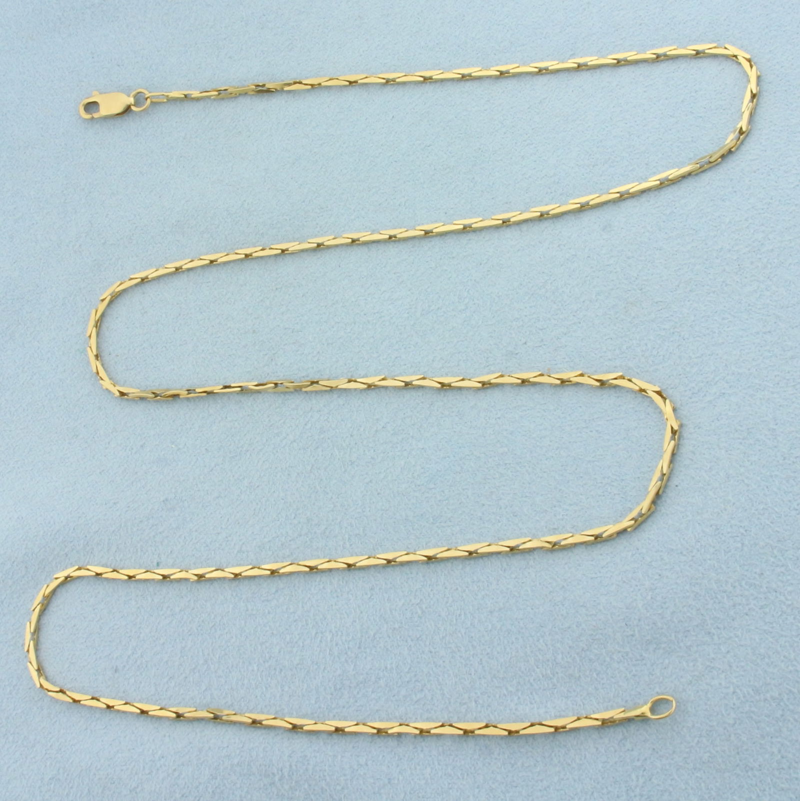 22 Inch Cobra Link Chain Necklace in 14k Yellow Gold: In 14k Yellow Gold. 22 inches long. 1.5mm wide. Lobster clasp. 7.6g.