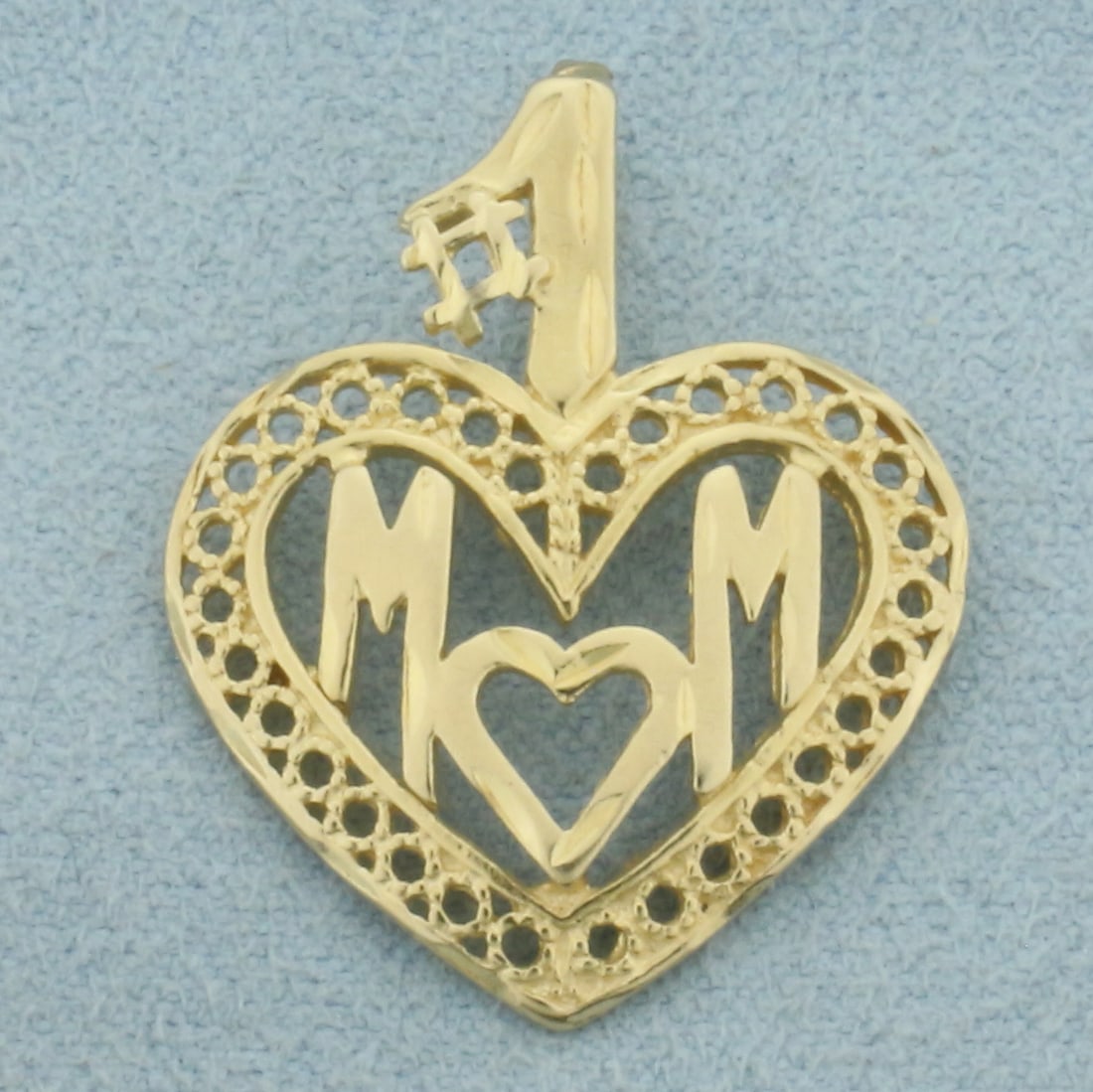 Number One Mom Heart Pendant in 14k Yellow Gold: In 14k Yellow Gold. 1 1/8 inch long including bale. 17/8 inch wide. 2.3g.