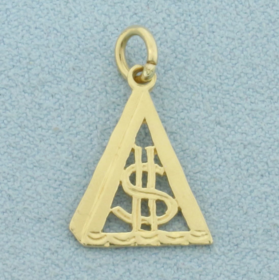 Dollar Sign Triangle Charm in 14k Yellow Gold: In 14k Yellow Gold. 3/4 inch long (including jump ring). 1/2 inch wide. 0.9g.