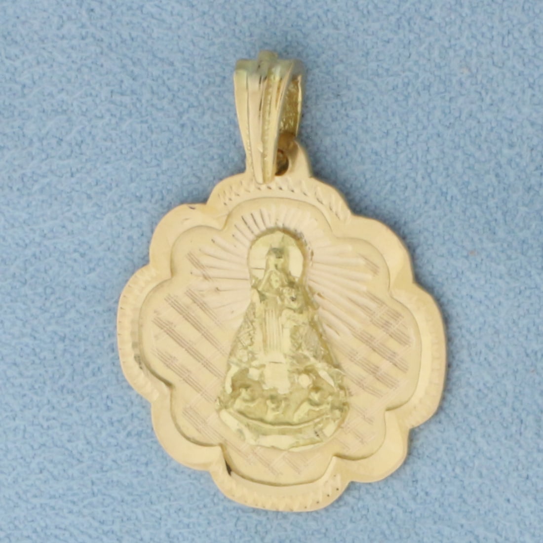 St. Caridad Our Lady of Charity Pendant in 18k Yellow Gold: In 18k Yellow Gold. 1 inch long (including bale). 3/4 inch wide. Patron Saint of Cuba. 2.9g.