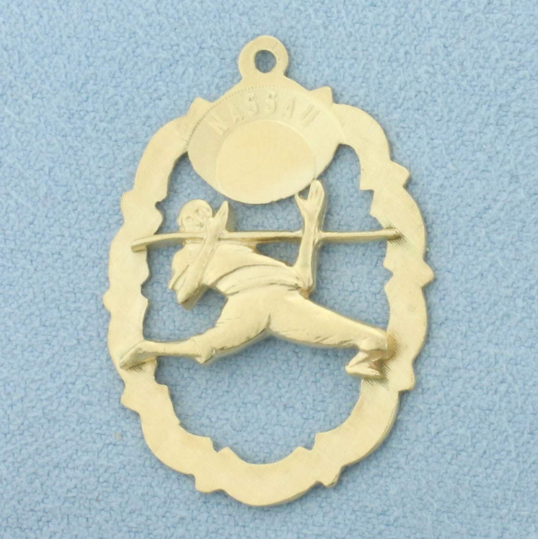 Nassau Limbo Dancer Charm or Pendant in 14k Yellow Gold: In 14k Yellow Gold. 1 1/4 inches long. 7/8 inch wide. 3.1g.