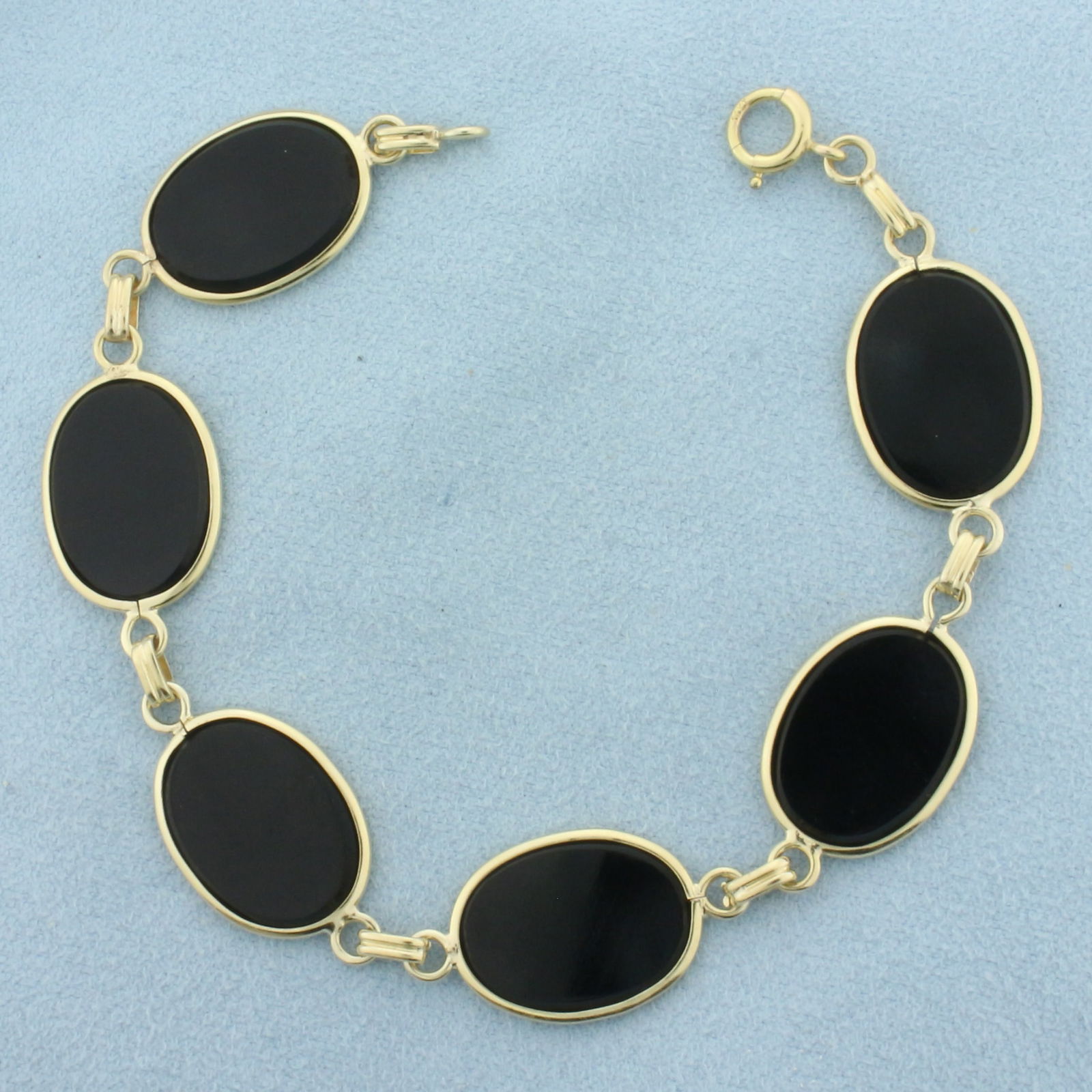 Onyx Link Bracelet in 14K Yellow Gold: In 14k yellow gold. Contains 6 high quality 12.5mm oval onyx gemstones. 7.5 inches long. Spring clasp. 10.8g.