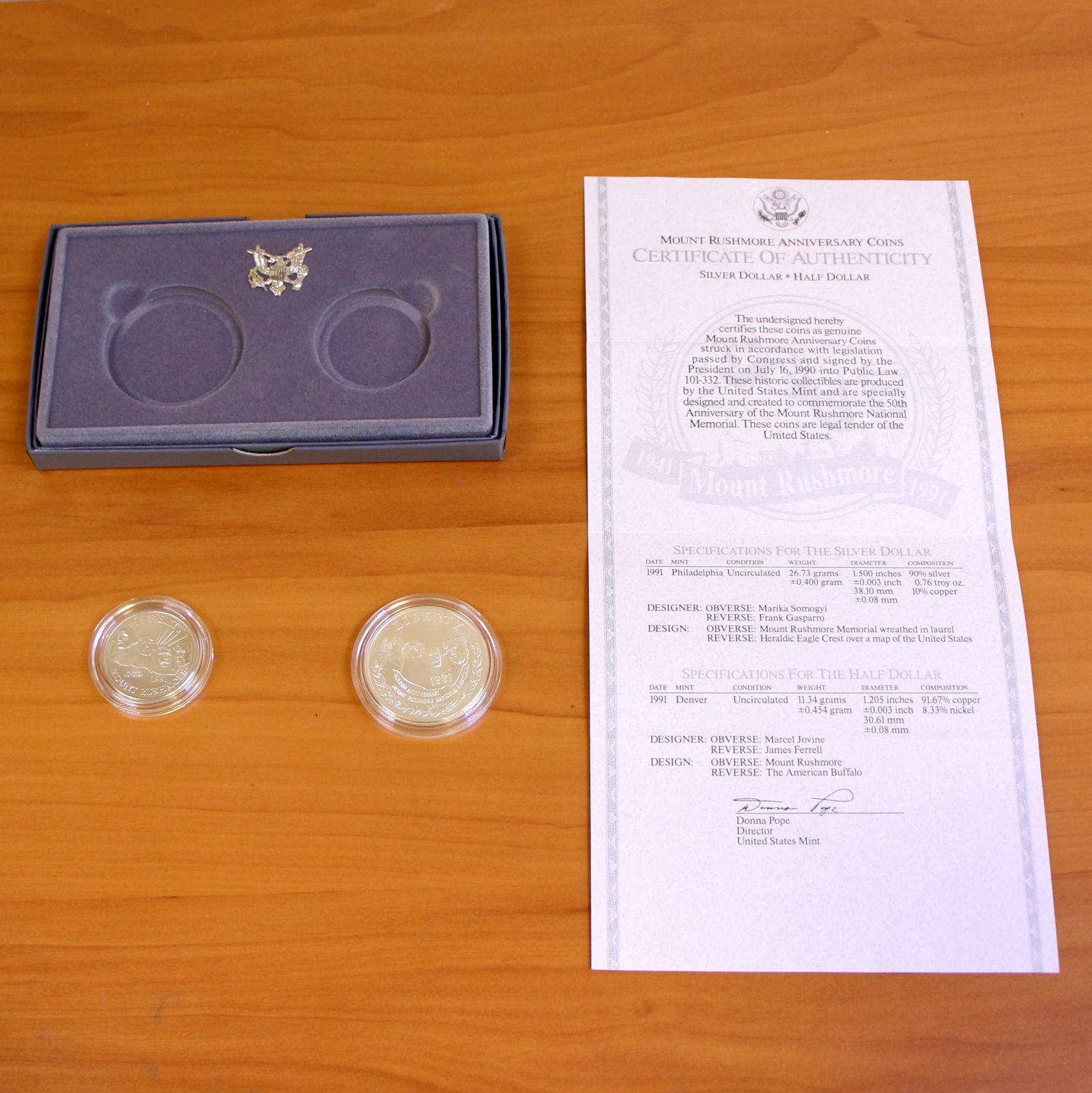US Mint Mount Rushmore Coin Set OGP: Contains one 1991 90% Silver Philadelphia Mint Mount Rushmore Silver Dollar and Denver Mint Half Dollar. Set in original government packaging and contains certificate of authenticity.