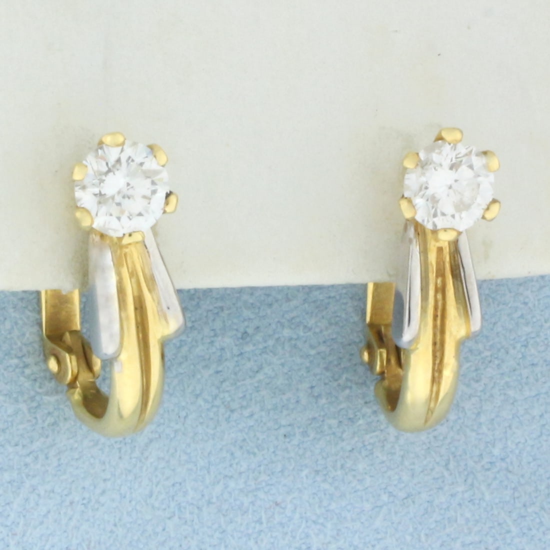 Diamond Stud Half Hoop Earrings in 18K Yellow and White Gold: In 18K Yellow and White Gold. Each earring contains one high quality 2/3ct round brilliant cut Diamond SI clarity/G color. 3/4 inches long. 3.2 5.3mm wide. 6.3g