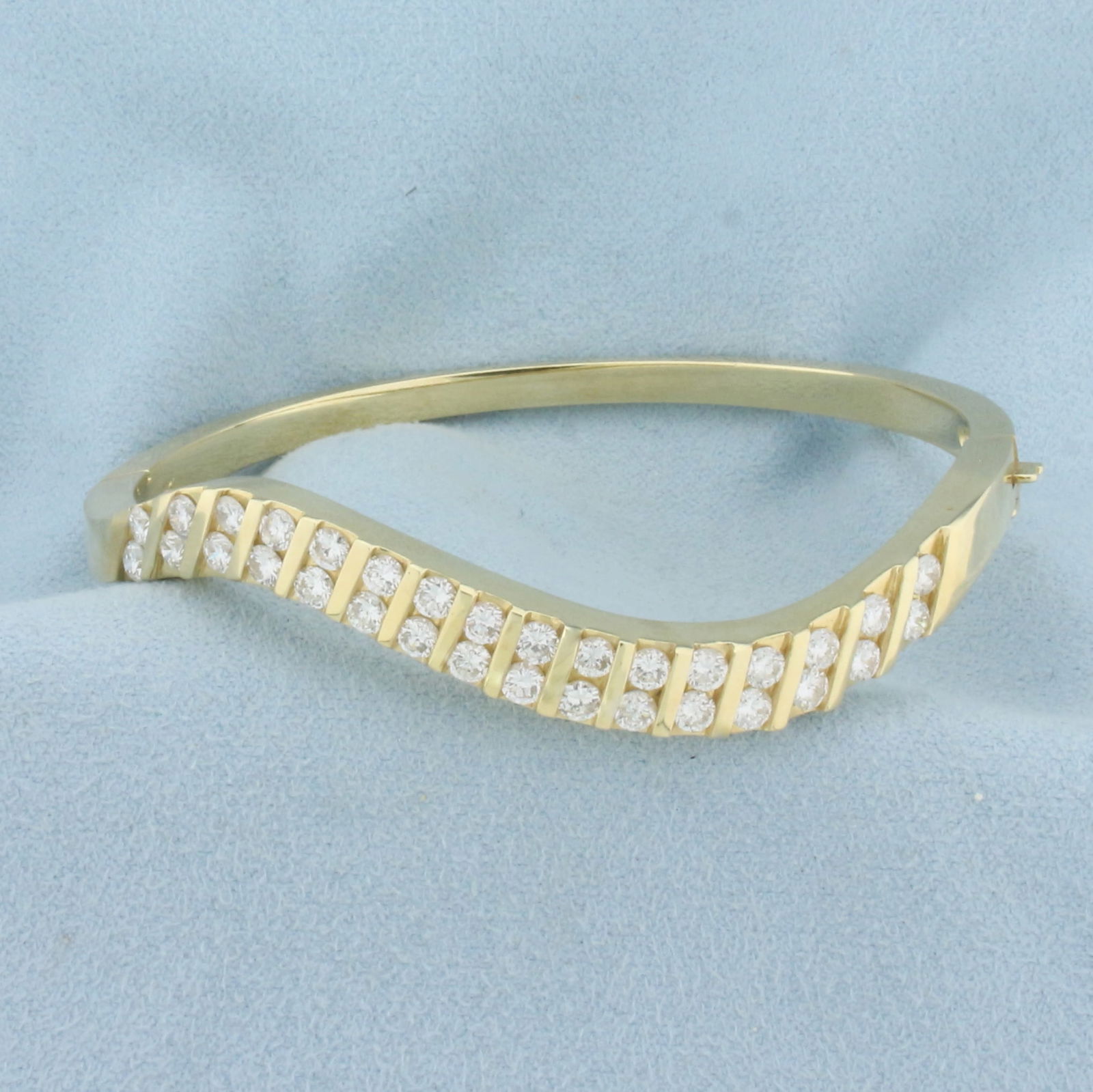 3ct TW Diamond Wave Design Bangle Bracelet in 14K Yellow Gold: In 14K Yellow Gold. Contains thirty two high quality diamonds, 3ct TW, VS clarity/F color. 2 1/2 inch inner diameter, 3.5 to 7mm thick. 28.4g.