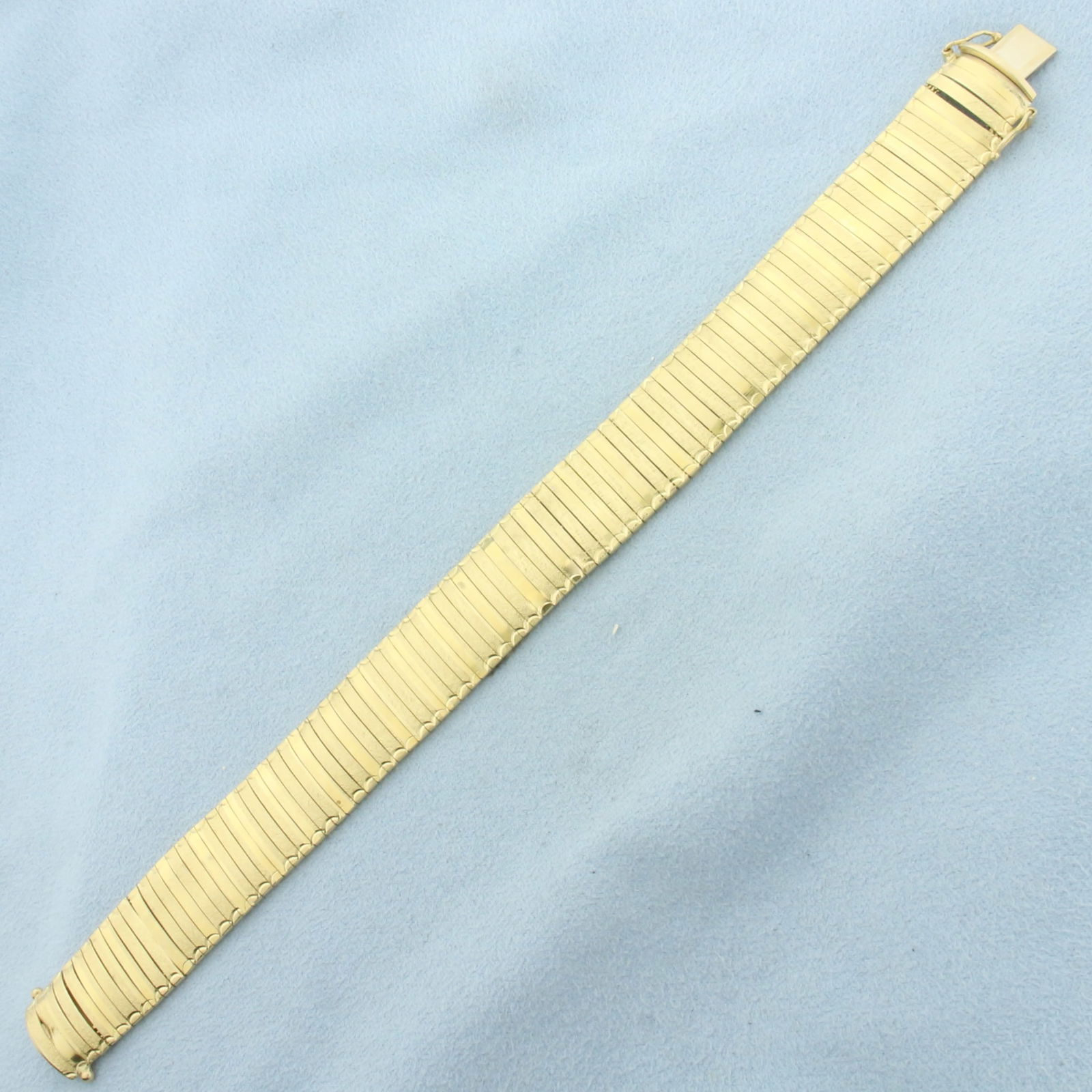 Italian Omega Link Bracelet in 14K Yellow Gold: in 14K Yellow Gold. Safety clasp. 7 1/4 inches long. 14.8mm wide. Alternate links are diamond cut for unique look. 23.4g