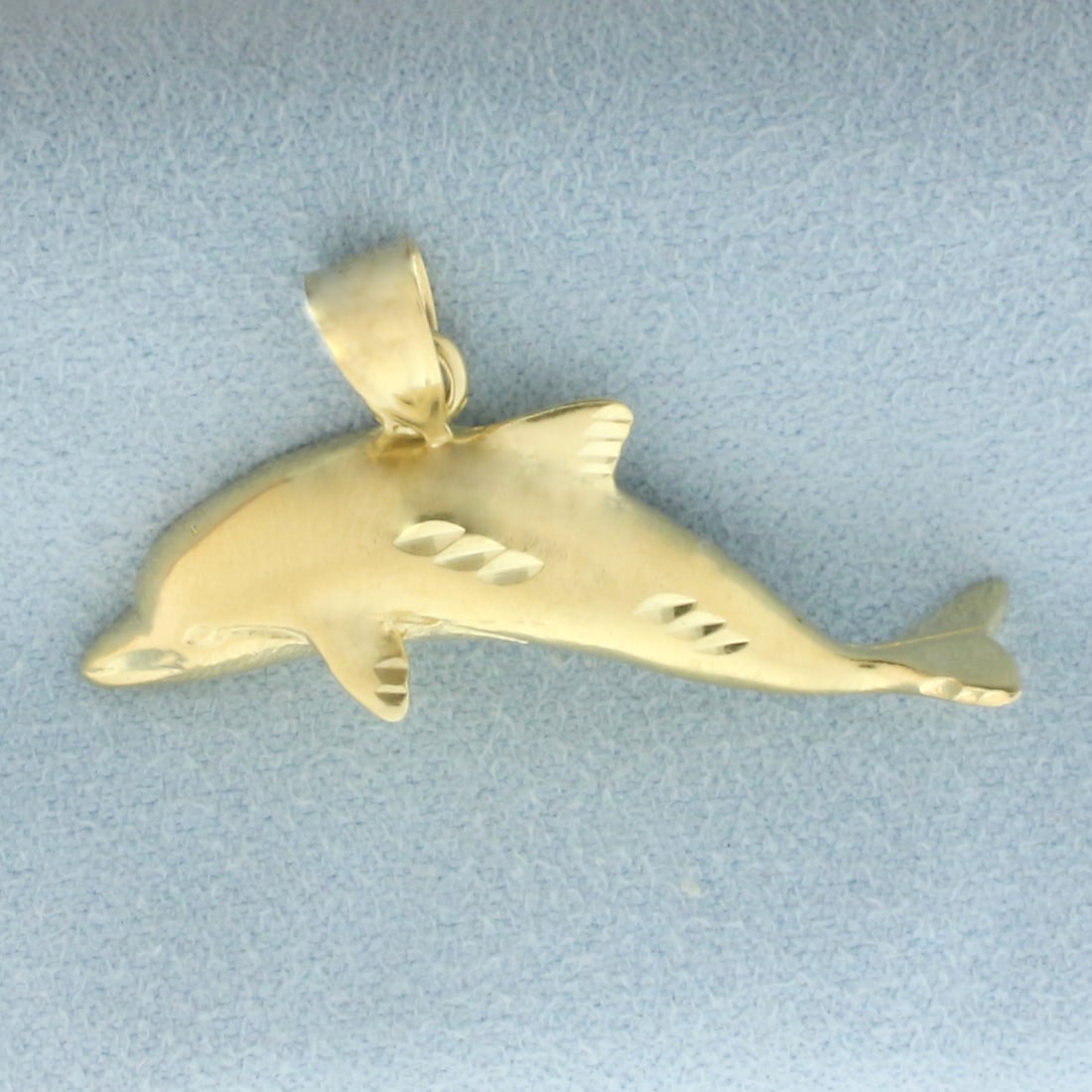 Diamond Cut Dolphin Pendant in 14k Yellow Gold: In 14k yellow gold. 1 3/8 inches wide and 1 inch long (including bale). 5.1g.