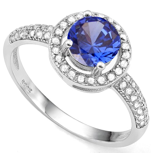 London Blue Topaz and White Sapphire Halo Ring in Sterling Silver: In platinum over .925 sterling silver. Contains one London Blue Topaz gemstone, 1.0cts, with excellent color and clarity. Accented with .28ctw white sapphires. Size 8. 1.8g