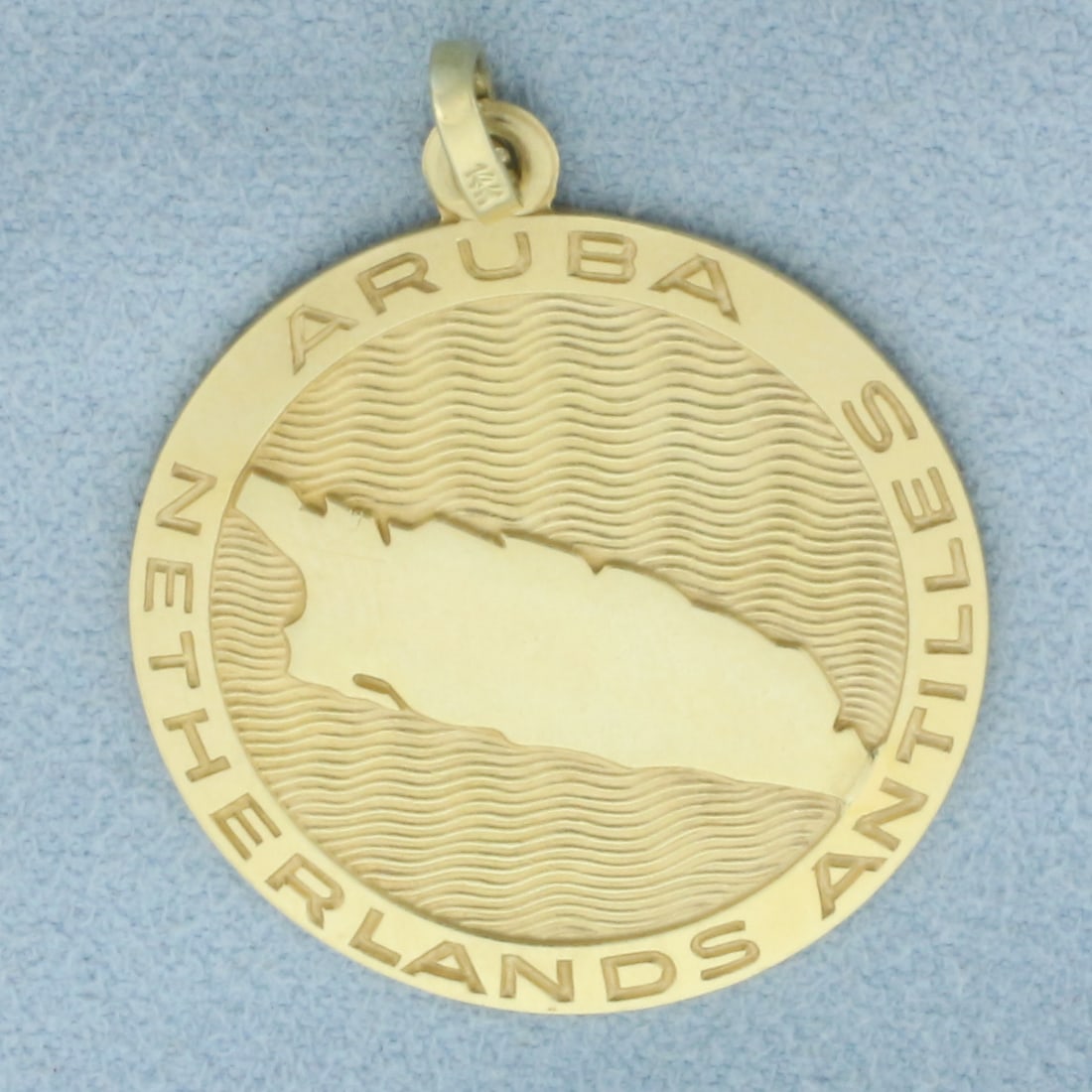 Aruba Netherlands Antilles Divi-Divi Tree Pendant or Charm in 14k Yellow Gold: In 14k yellow gold. 1 3/8 inches long (including jump ring) by 1 inch wide. 6.3g.