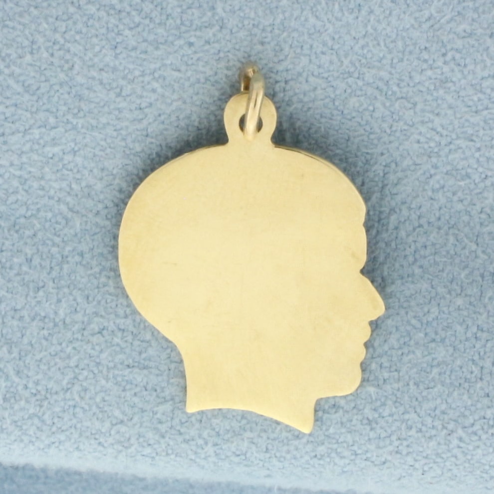 Engravable Boy Silhouette Charm in 14k Yellow Gold: In 14k Yellow Gold. 1 inch long, 5/8 inch wide. Can engrave name or date on either side. 1.8g.