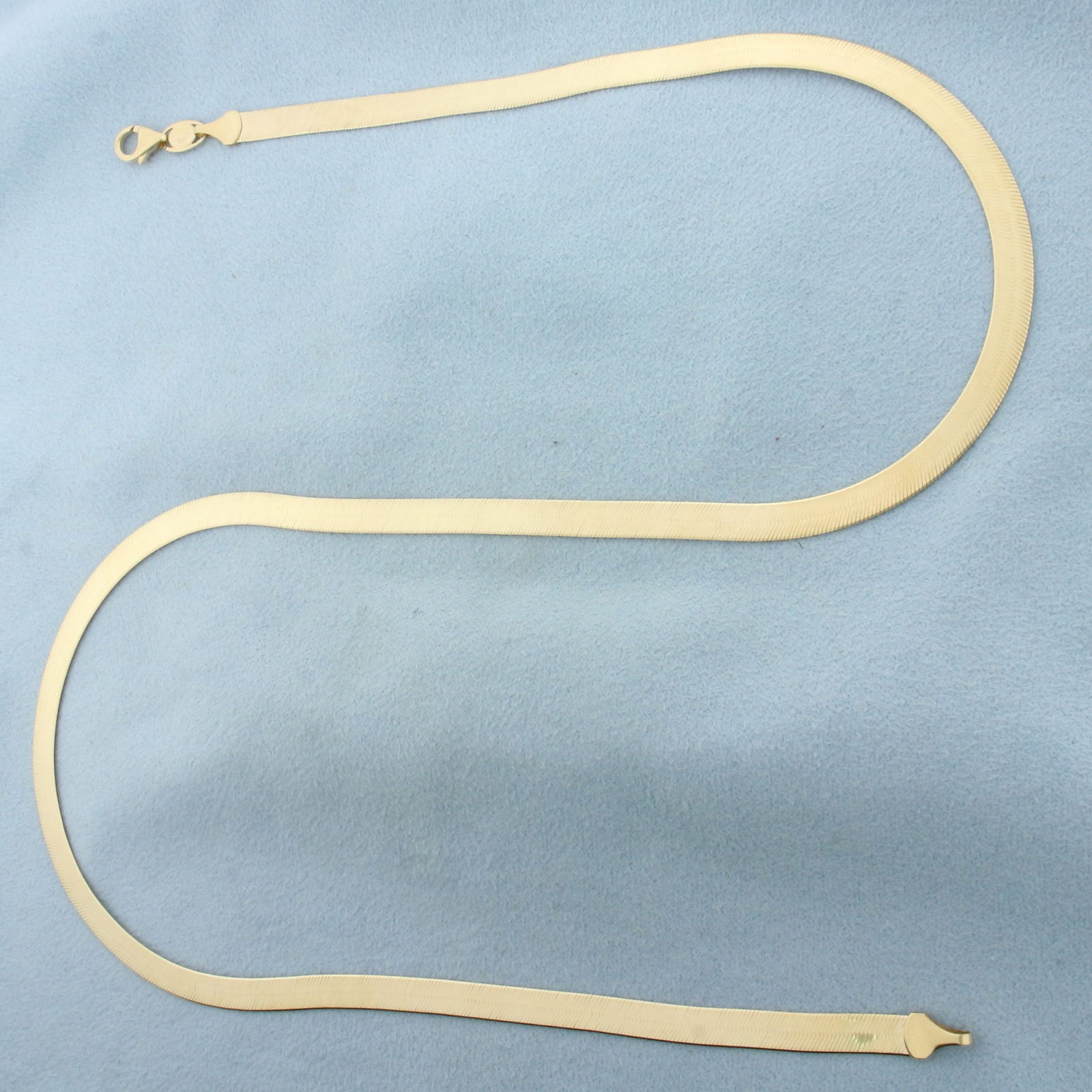 20 Inch Italian Liquid Gold Herringbone Chain Necklace in 14k Yellow Gold: In 14k Yellow Gold. 20 inches long. 5mm wide. Lobster clasp. 11.0g.