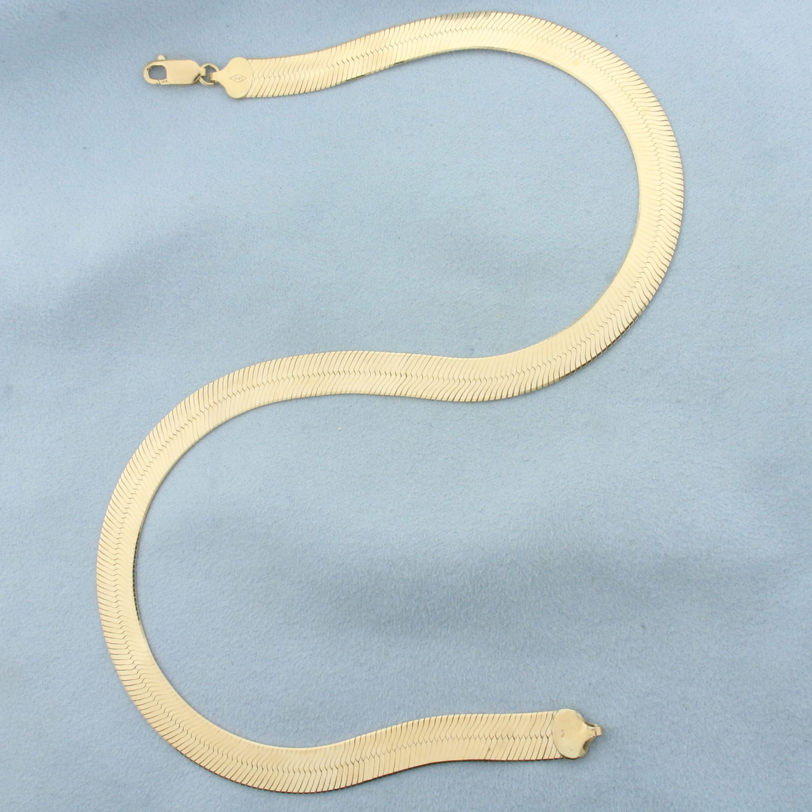 16 Inch Liquid Gold Wide Herringbone Necklace in 14k Yellow Gold: In 14k Yellow Gold. 16 inches long. 9mm wide. Lobster clasp. 23.9g.