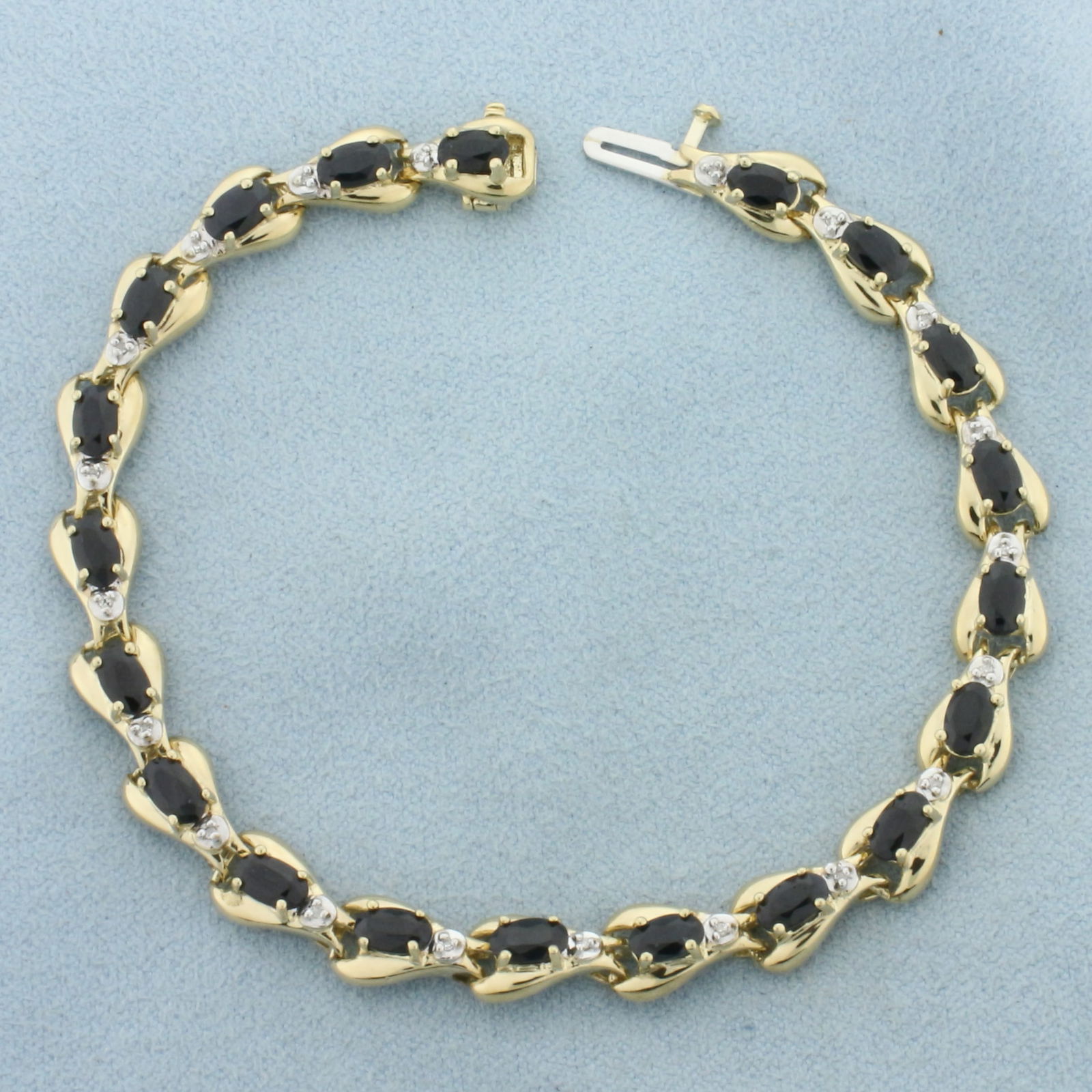 Sapphire and Diamond Tennis Bracelet in 10k Yellow Gold: In 10k Yellow Gold. Contains twenty 5x3mm high quality natural Sapphire gemstones with deep blue color. Also contains twenty 1/2pt high quality diamonds. 7 1/4 inches long. 6.5mm wide. Concealed slide